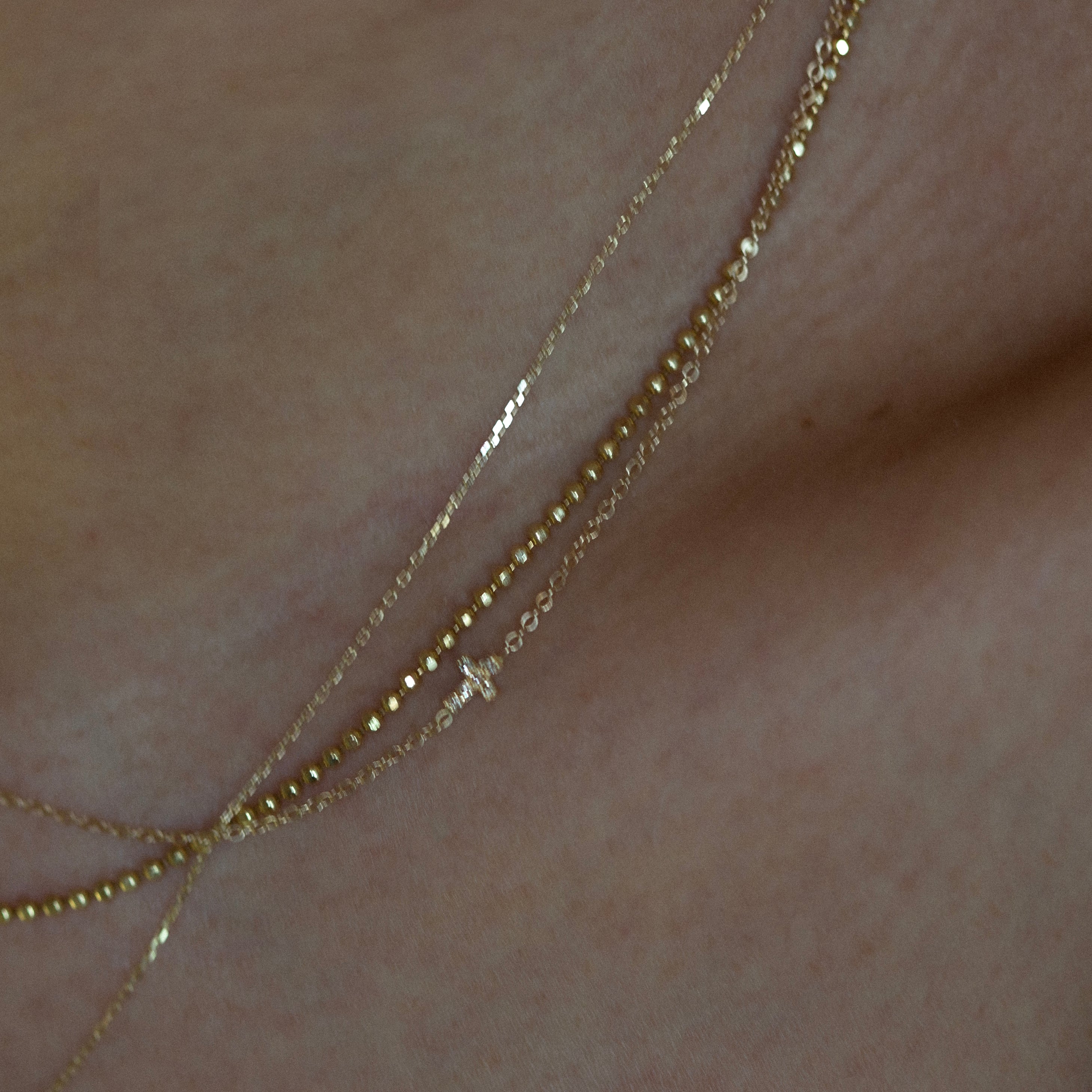Asymmetrical Diamond cross necklace - This simple cross necklace is both understated and significant, perfect for daily wear and layering with other necklaces. Ideal for a confirmation or baptism present, this minimalistic necklace features a delicate chain and a sparkling diamond charm, symbolizing faith.