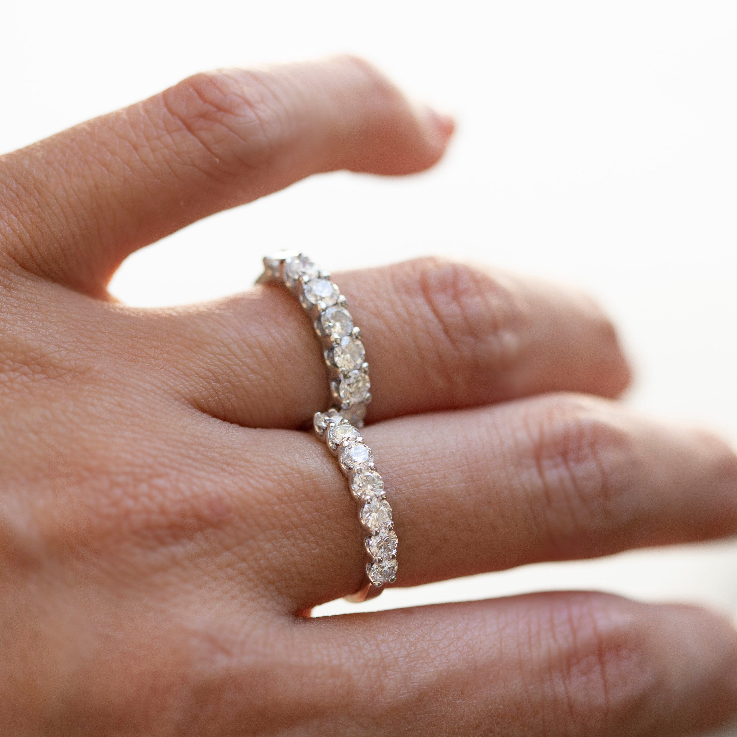 Diamond ring on a hand with a blurred background