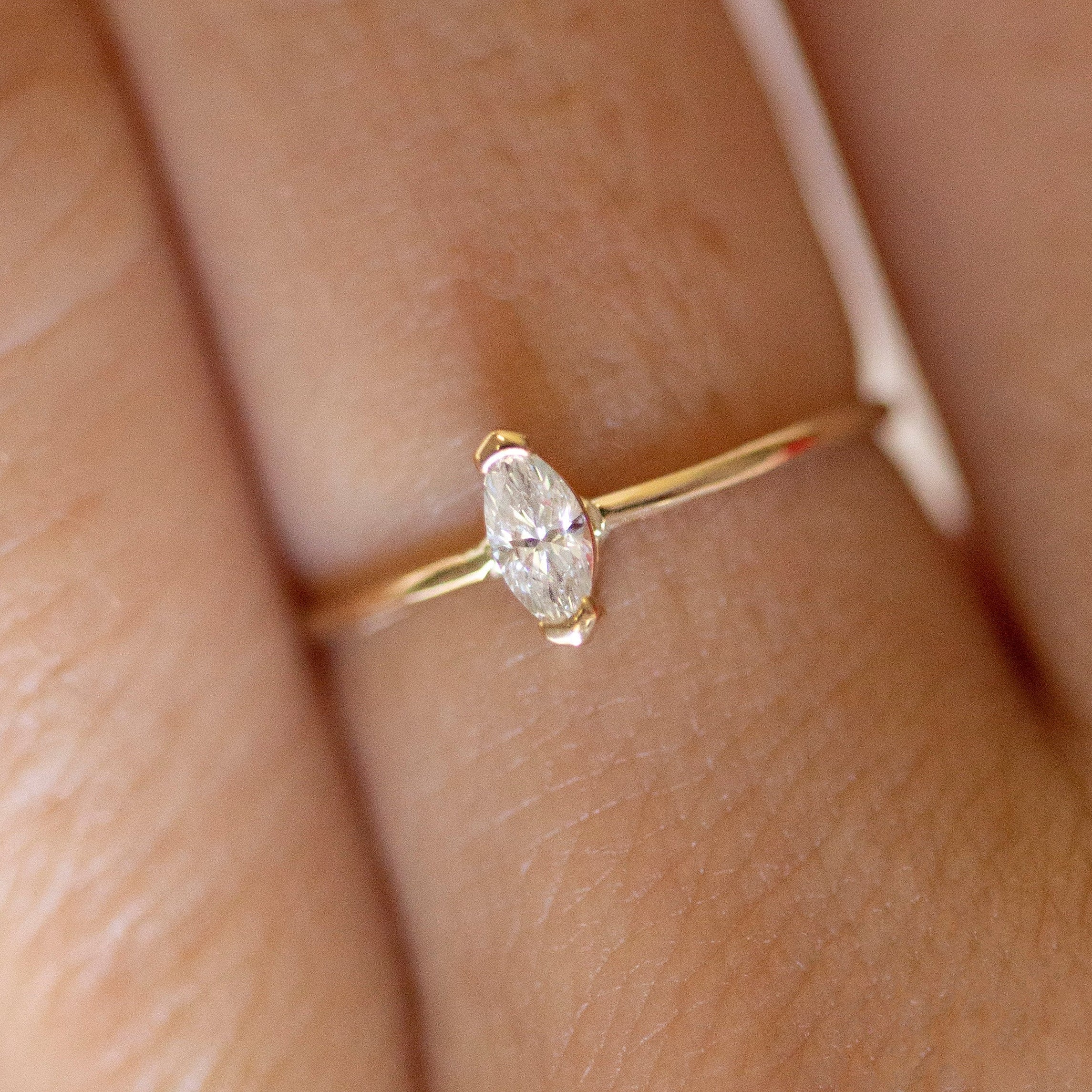 Gold ring with a diamond on a finger