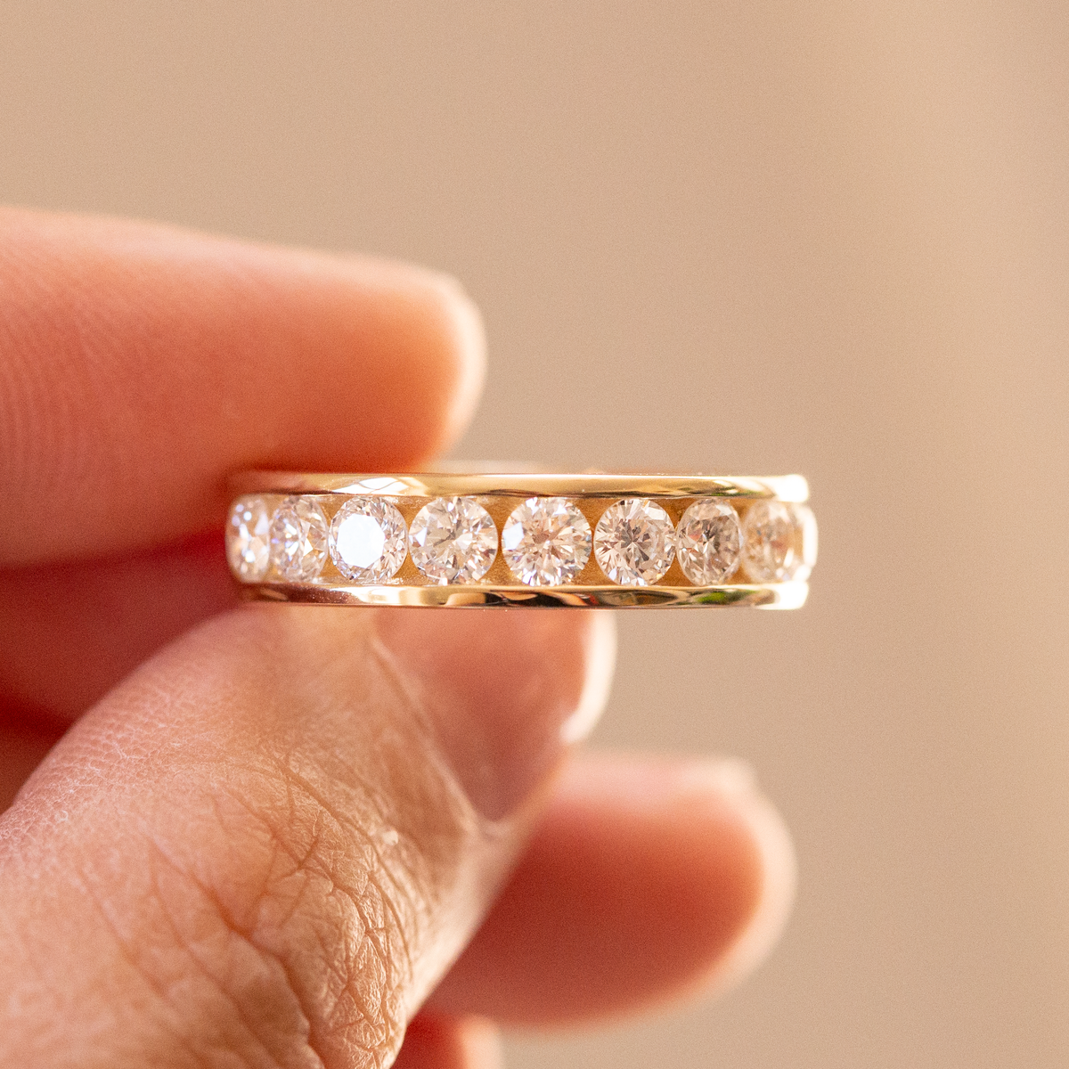14K yellow gold channel set ring featuring 10 round brilliant lab-grown diamonds on a clean white background.