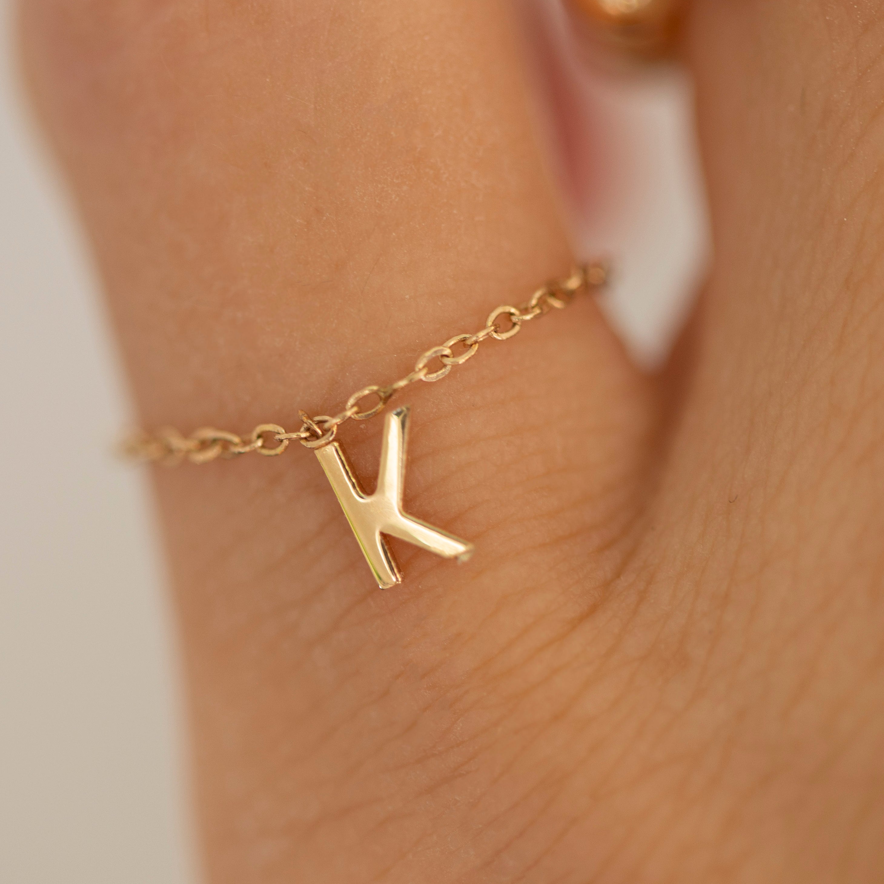 Barely there ring in 14k gold with small initial letter