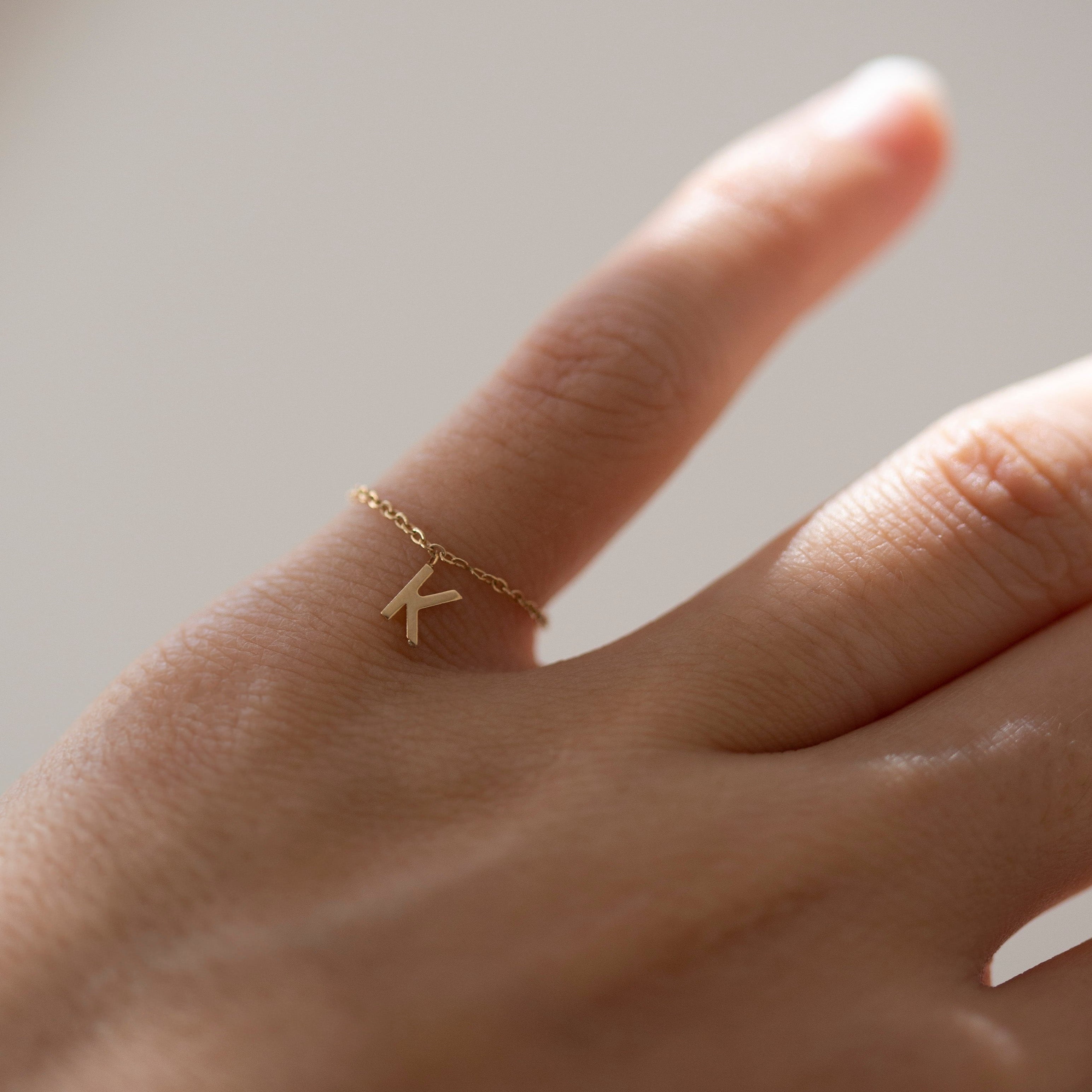Barely there ring in 14k gold with a small initial letter dangle