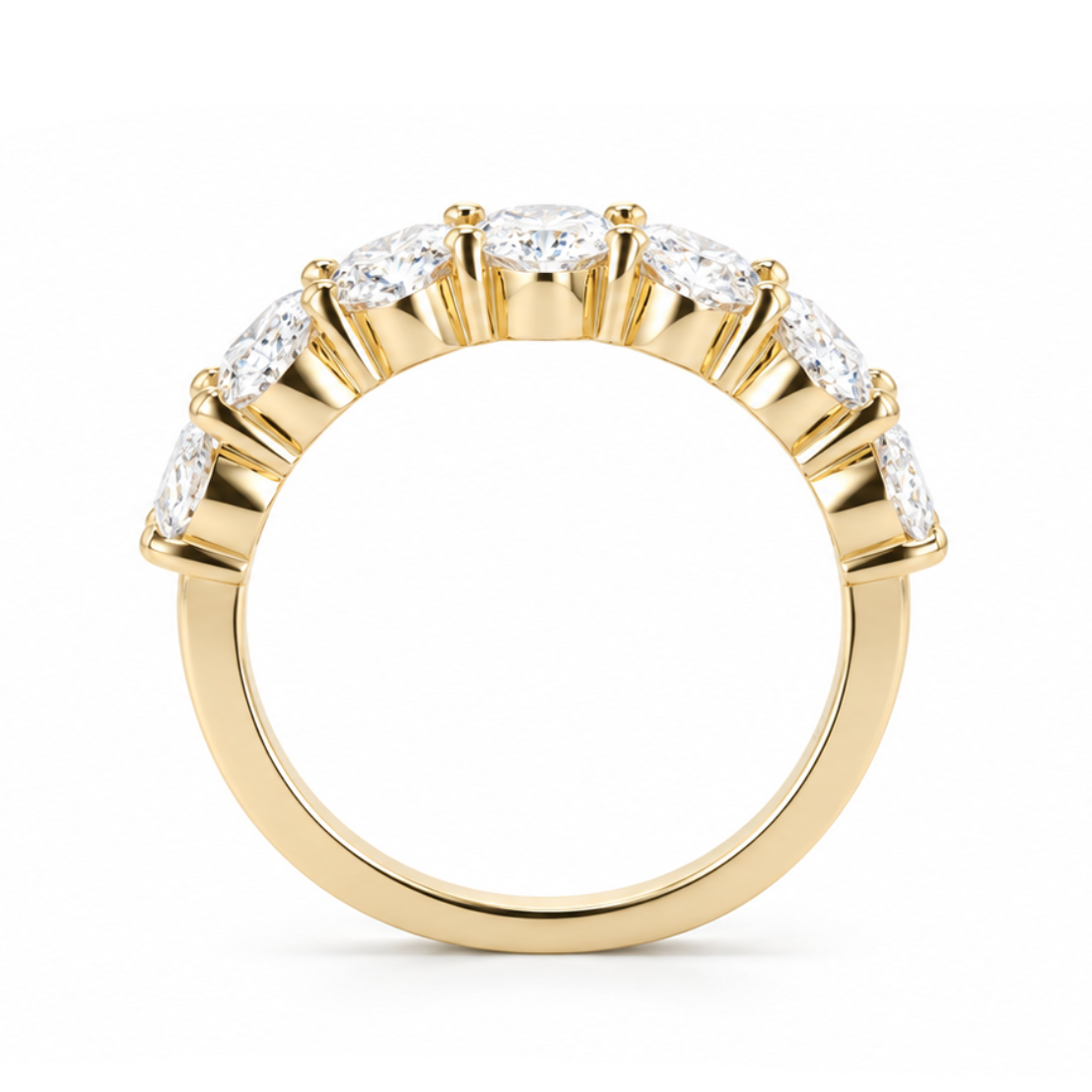 A yellow gold ring featuring a curved row of clear oval-cut gemstones in a prong setting, shown against a plain white background.