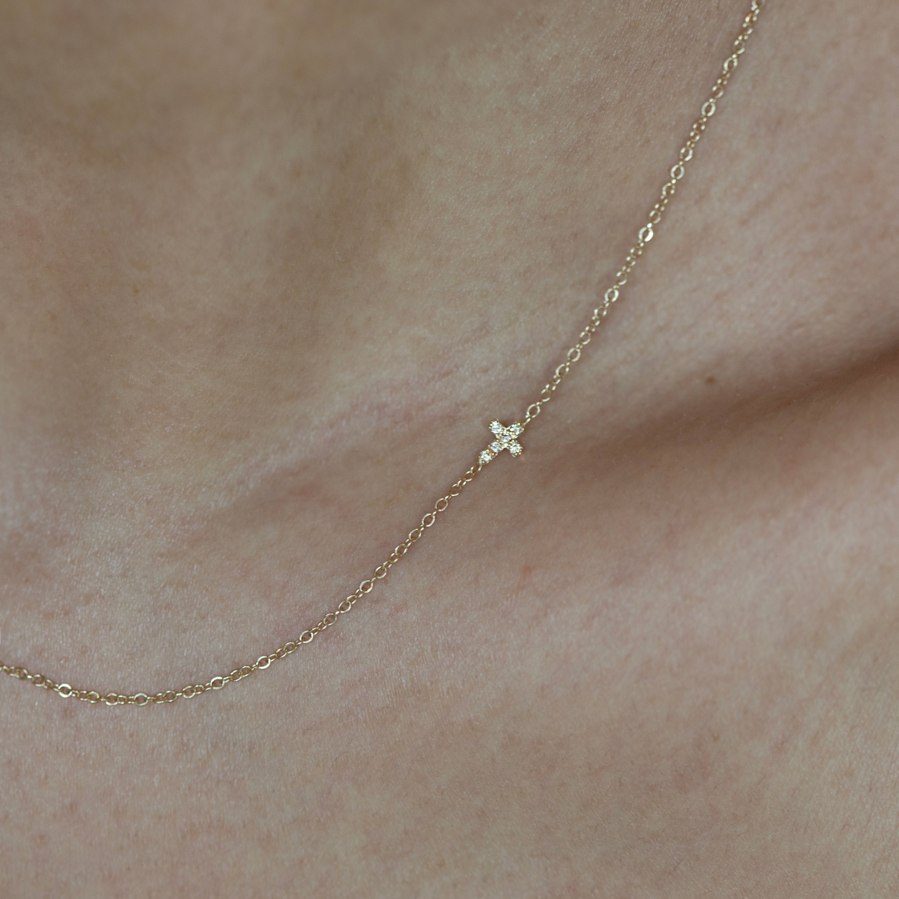 Asymmetrical Diamond cross necklace - This simple cross necklace is both understated and significant, perfect for daily wear and layering with other necklaces. Ideal for a confirmation or baptism present, this minimalistic necklace features a delicate chain and a sparkling diamond charm, symbolizing faith.