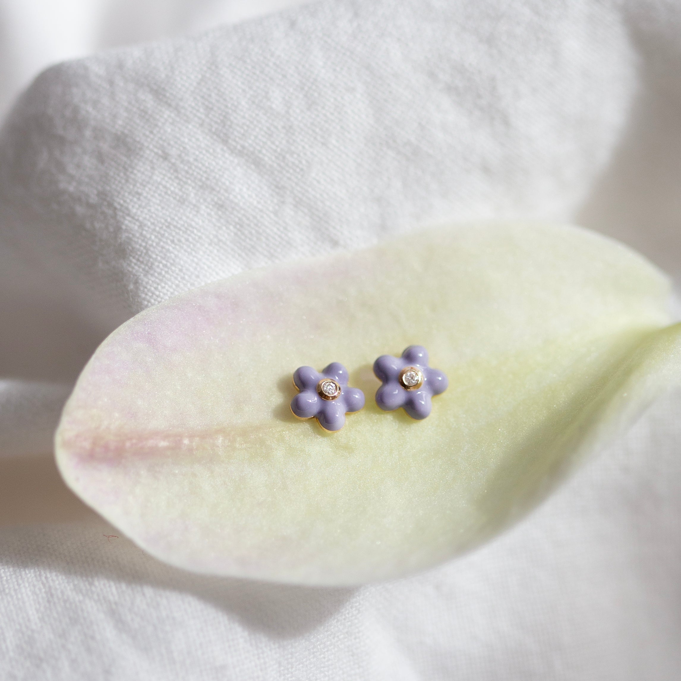 beautiful violet enamel flower and a sparkling diamond accent.