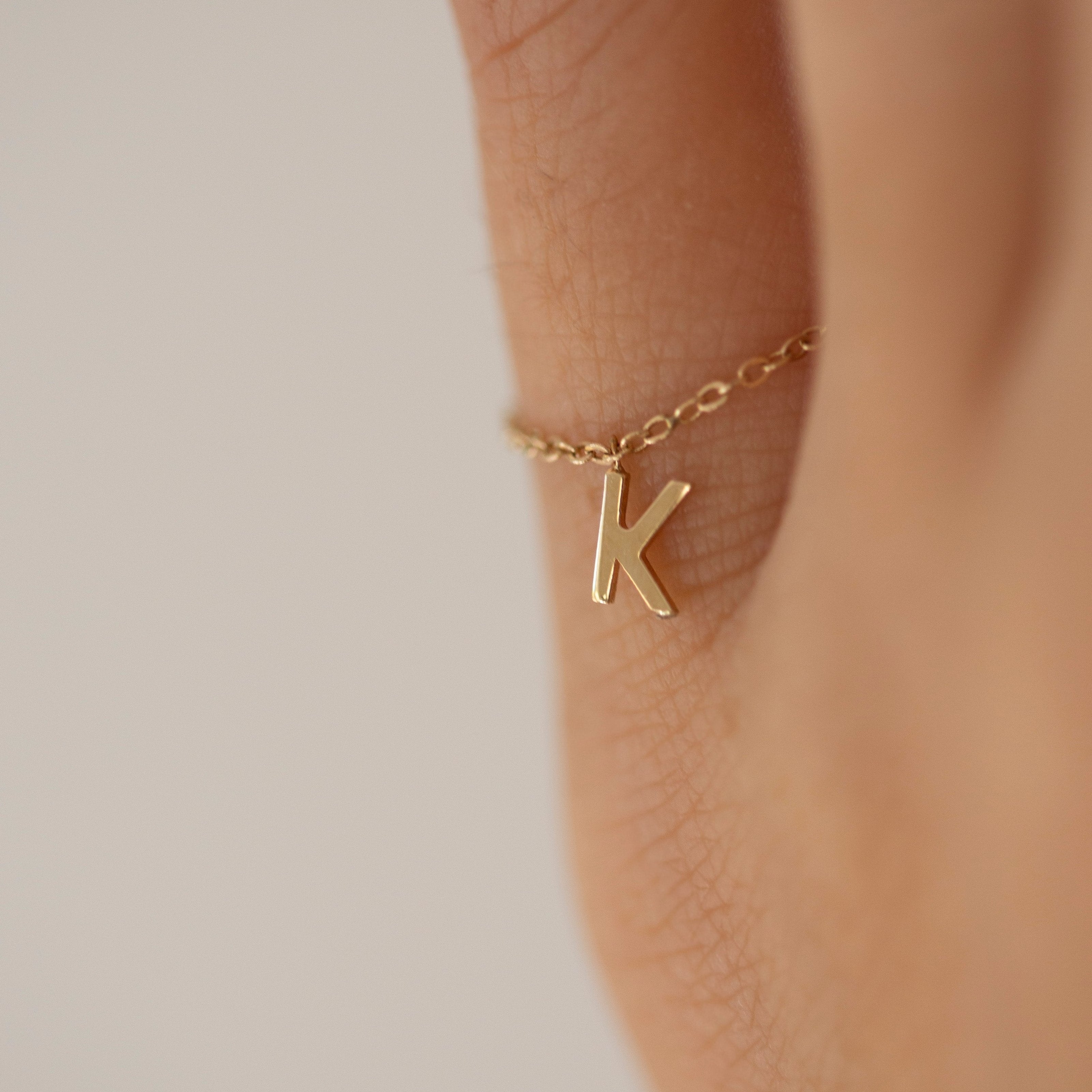 Barely there ring in 14k gold with small initial letter