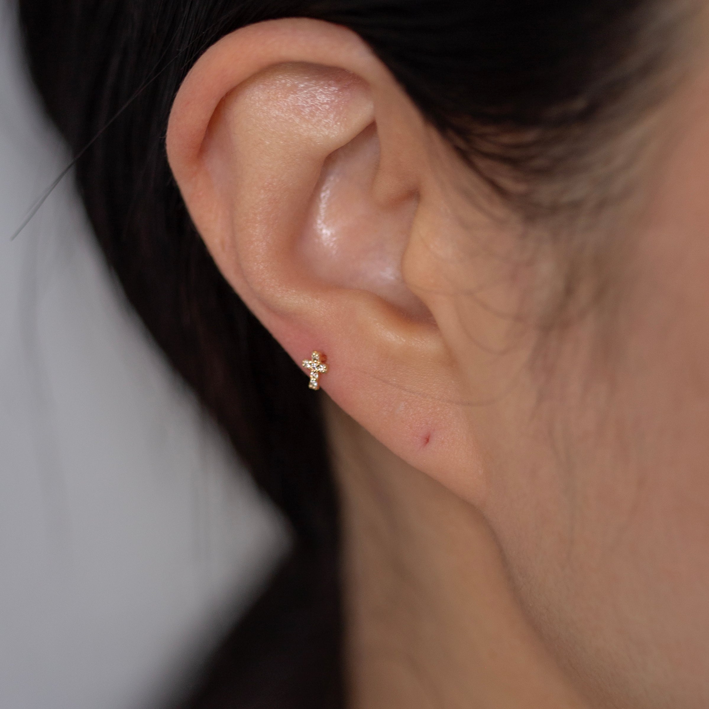 This delicate cross stud earring is made of 14K solid gold and sparkling bright diamond stones. Perfect for pairing with any of your favorite stud earrings.