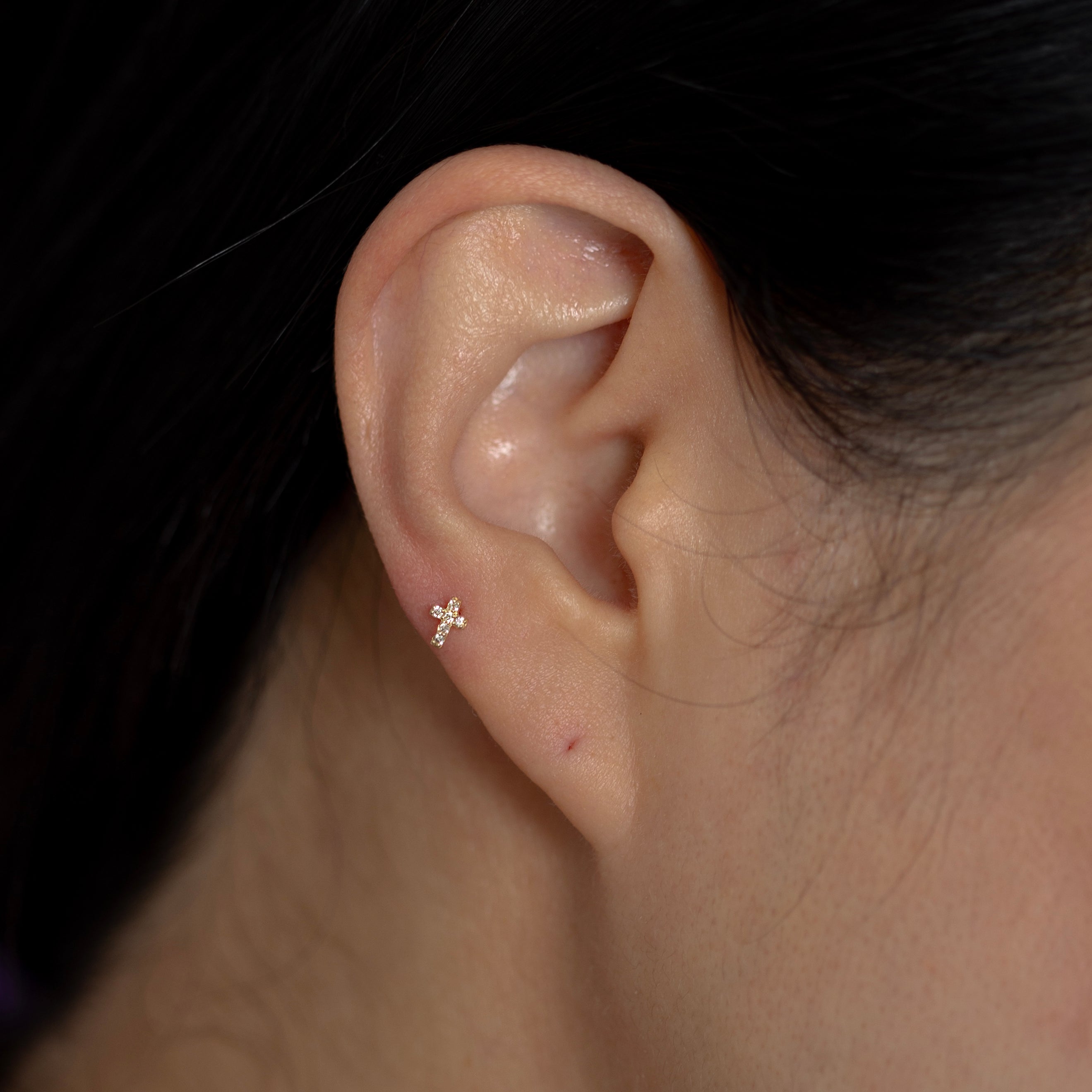 This delicate cross stud earring is made of 14K solid gold and sparkling bright diamond stones. Perfect for pairing with any of your favorite stud earrings.