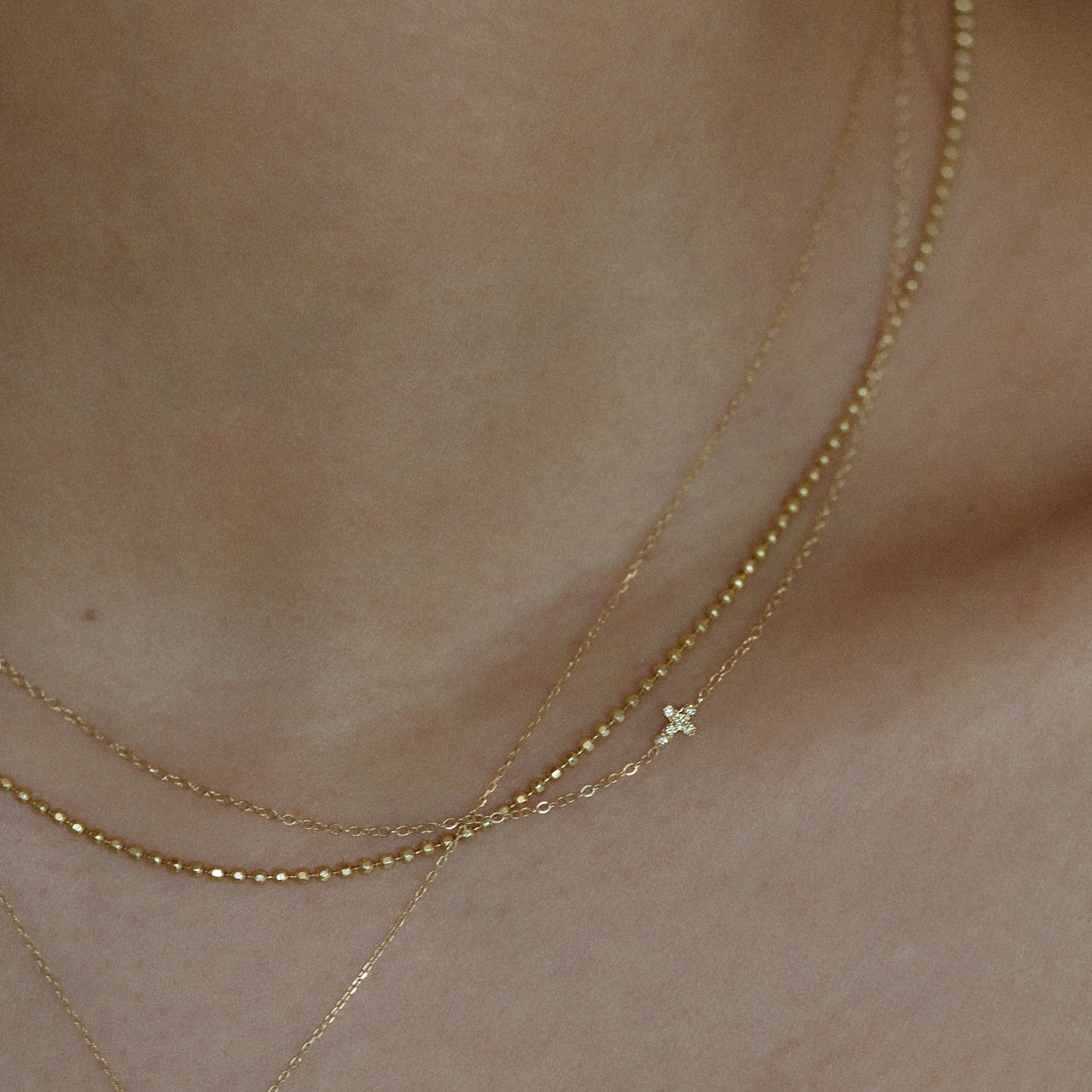 Asymmetrical Diamond cross necklace - This simple cross necklace is both understated and significant, perfect for daily wear and layering with other necklaces. Ideal for a confirmation or baptism present, this minimalistic necklace features a delicate chain and a sparkling diamond charm, symbolizing faith.