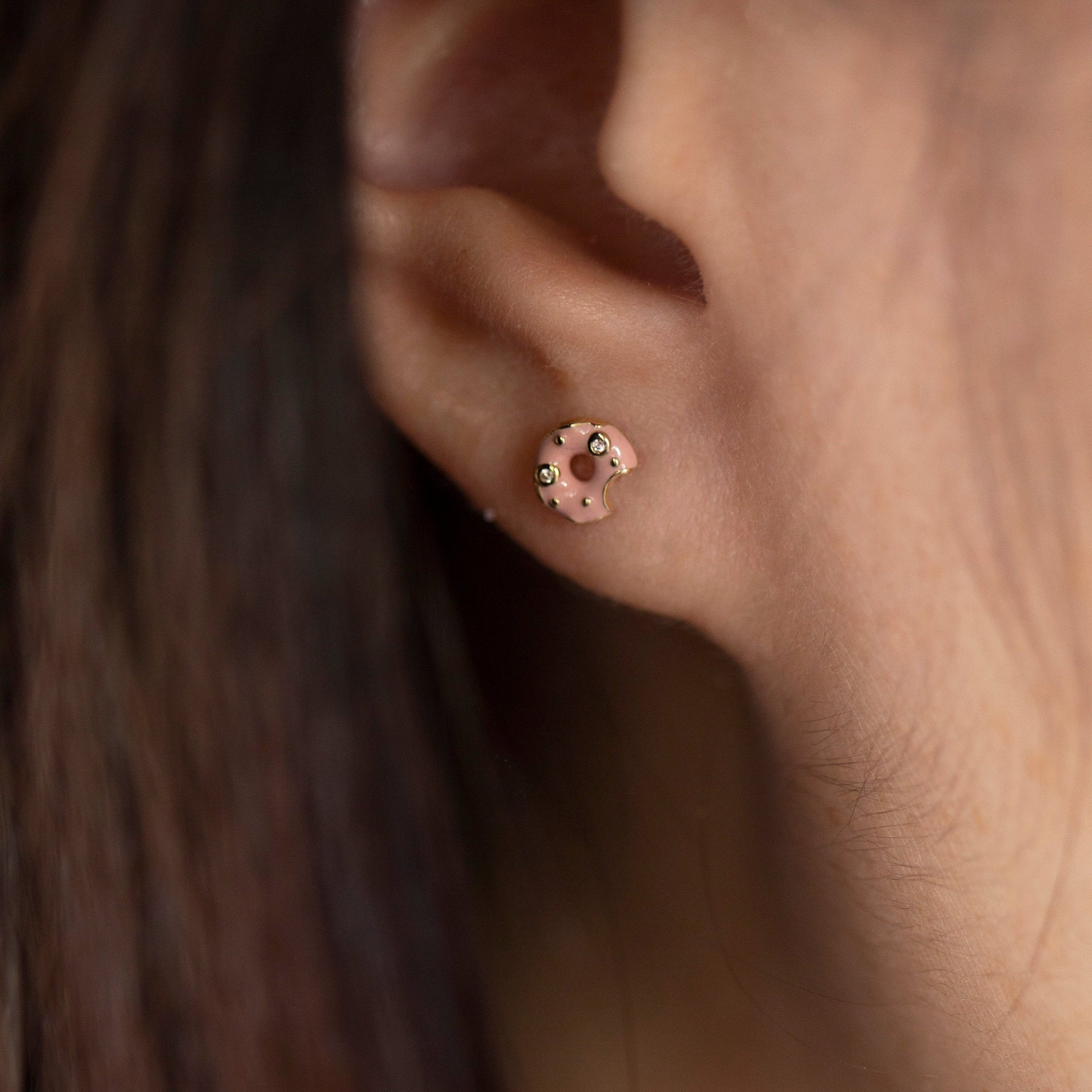 Elevate your style with these 14k diamond and enamel donut post earrings, crafted with brilliant diamond sprinkles and pink enamel frosting. 