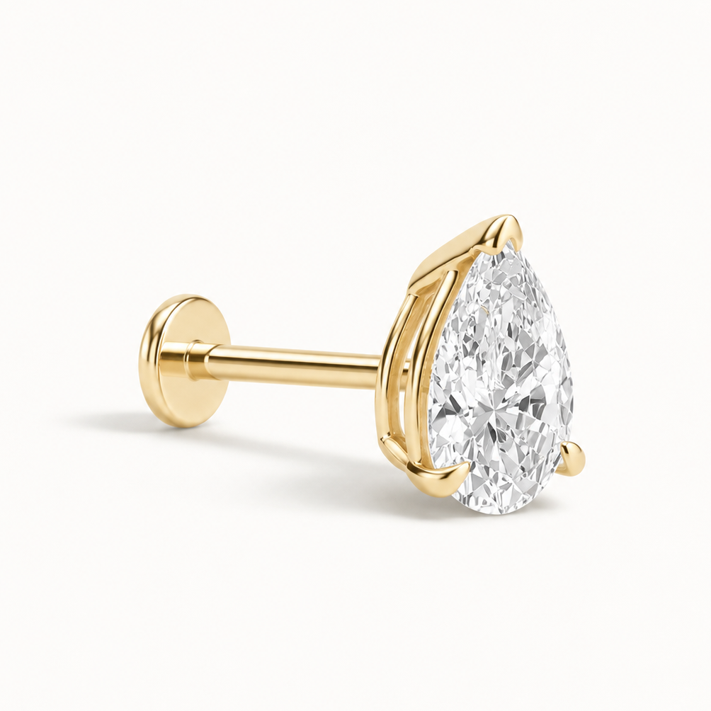 A pear-cut diamond stud earring in yellow gold, featuring a brilliant-cut clear gemstone set in a four-prong gold setting on a post with a flat back, shown on a clean white background.