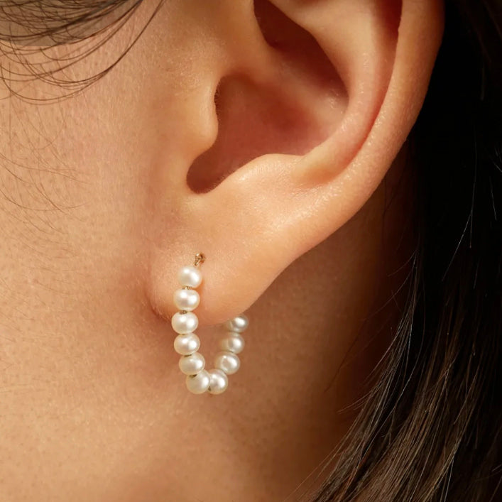 These 14k gold Freshwater Pearl Strand Earrings are a timeless and elegant accessory. Crafted from 14k yellow gold and freshwater pearls, they make an ideal bridal jewelry or bridesmaid gift. Their classic style make them a must-have in any woman's jewelry collection.