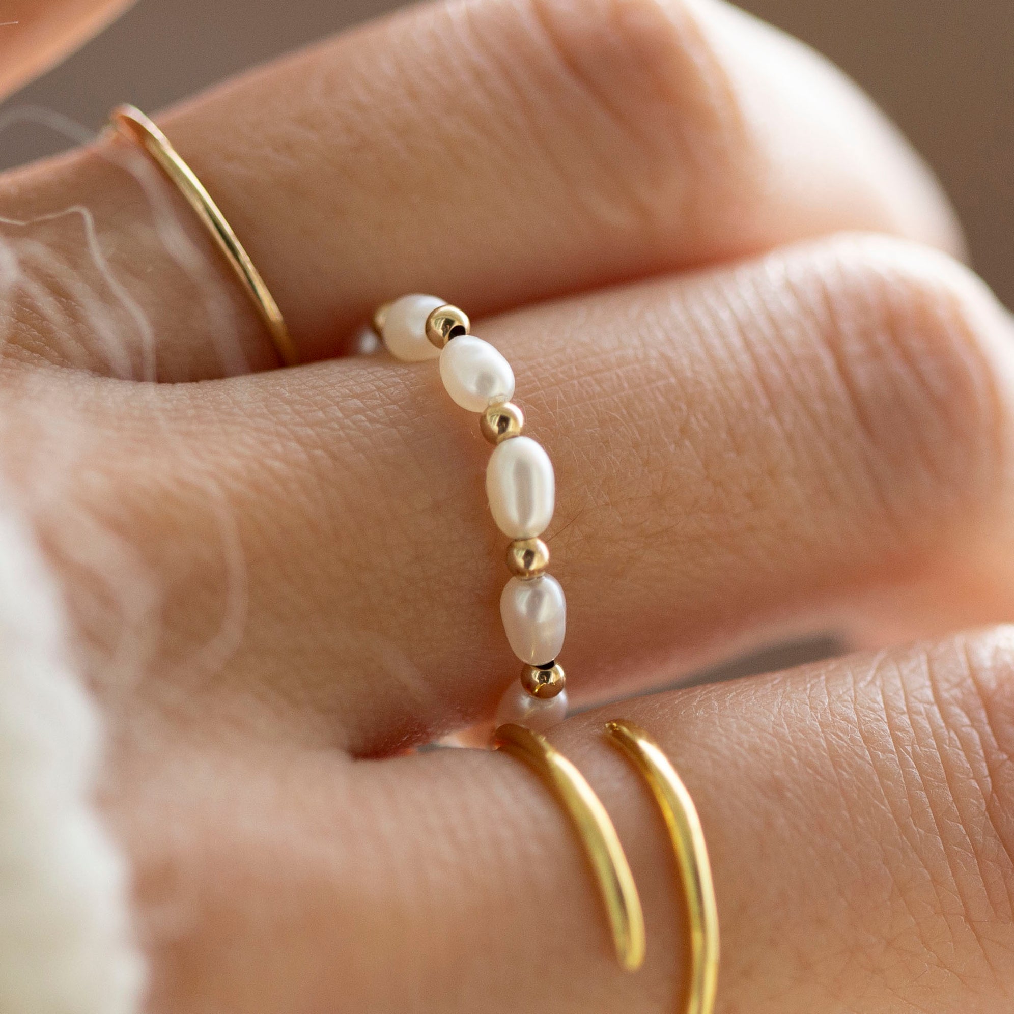 Baby Lotus Pearl Ring with Baby Beads
Made with mini rice shape fresh water pearls and mini gold filled bead on a
comfy stretchy elastic band. Baby lotus pearl ring will be the perfect addition to your ring stack!