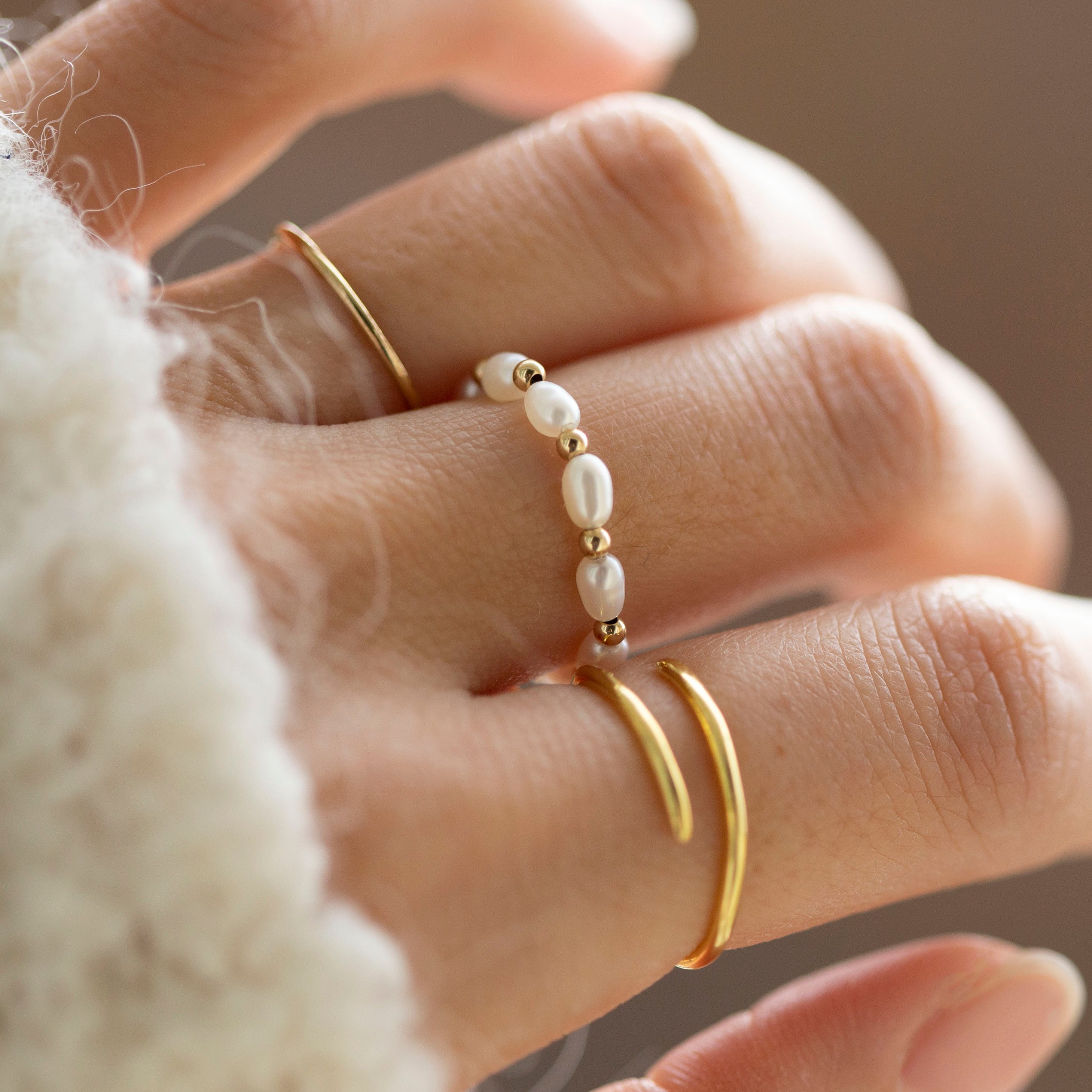 Baby Lotus Pearl Ring with Baby Beads
Made with mini rice shape fresh water pearls and mini gold filled bead on a
comfy stretchy elastic band. Baby lotus pearl ring will be the perfect addition to your ring stack!