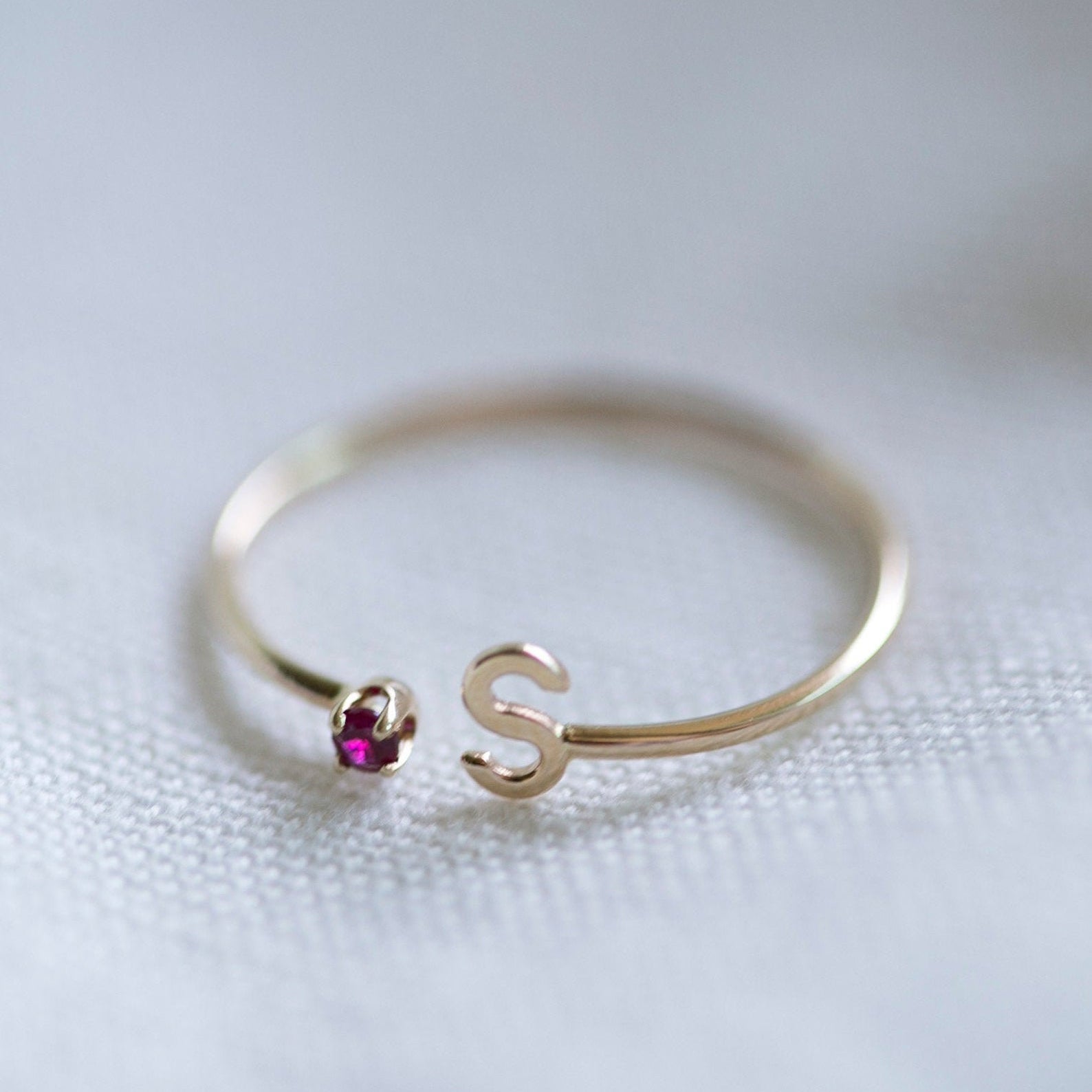 Elevate your style with our exquisite 14k Gold Initial Ring, adorned with a birthstone of your choice. Personalize it with an Uppercase letter A-Z, making it a one-of-a-kind piece. A thoughtful and luxurious gift for yourself or someone special.