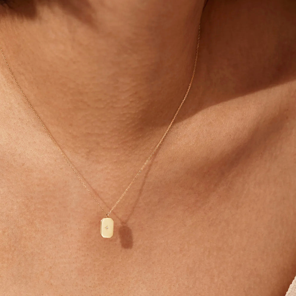 This 14k Gold Mini Diamond Tag Necklace is minimalistic and simple, yet adds a special touch with its small diamond star tag. It provides the perfect everyday accessory when worn alone or layered with other necklaces.