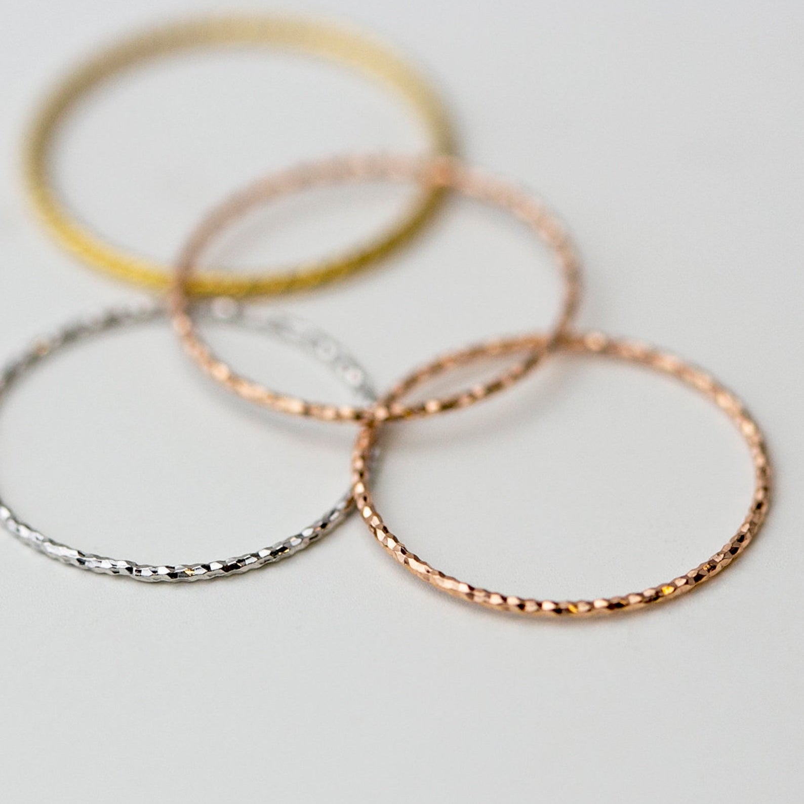 Crafted from 14k gold and featuring a diamond-cut design, these stacking rings offer a dainty and simplistic look that is perfect for everyday wear.