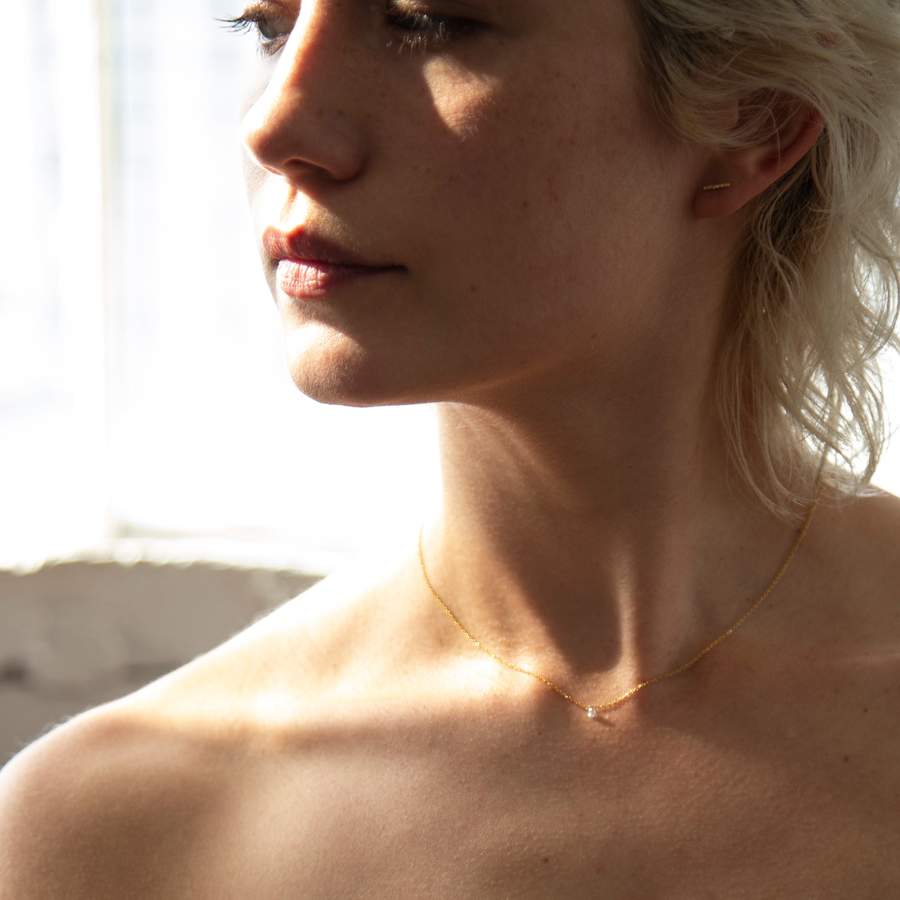 14k Gold chain with beautiful diamond in a drilled jump ring setting
This gorgeous minimalist diamond solitaire necklace features a .1ct round brilliant diamond on a dainty chain as if the diamond was naked.