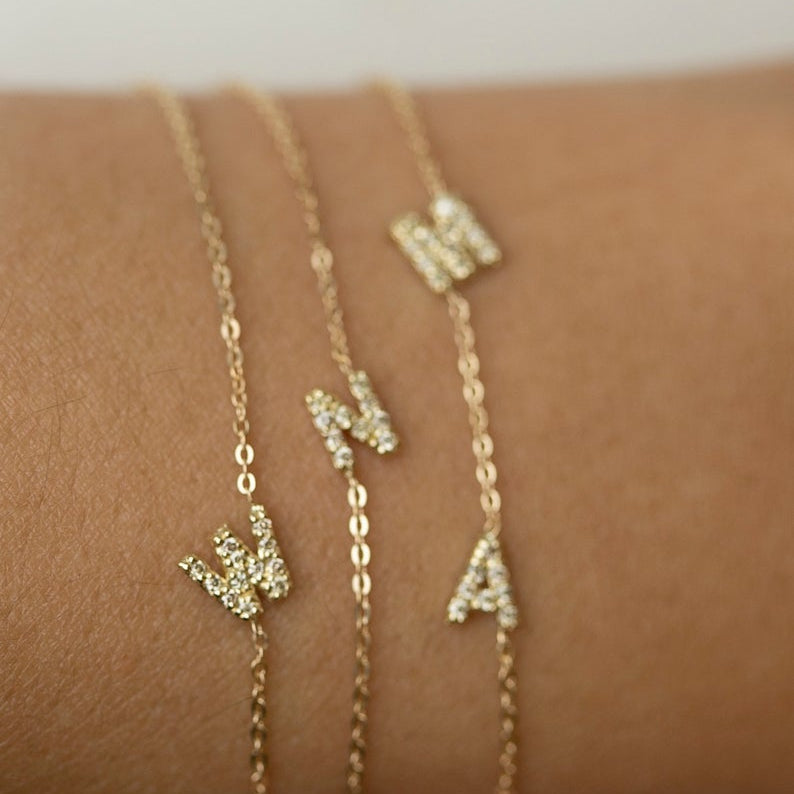 Personalized 14k solid gold mini diamond letter bracelet!
Indulge in understated luxury with our 14k Gold Mini Diamond Initial Bracelet, a delicate yet dazzling addition to your daily wardrobe. Adorned with a sparkling diamond and customizable with your choice of uppercase alphabet initial, this bracelet adds a touch of elegance and personalization to any outfit. The perfect choice for the woman who values simplicity and sophistication in her everyday style.
Great as a gift for special someone or for your