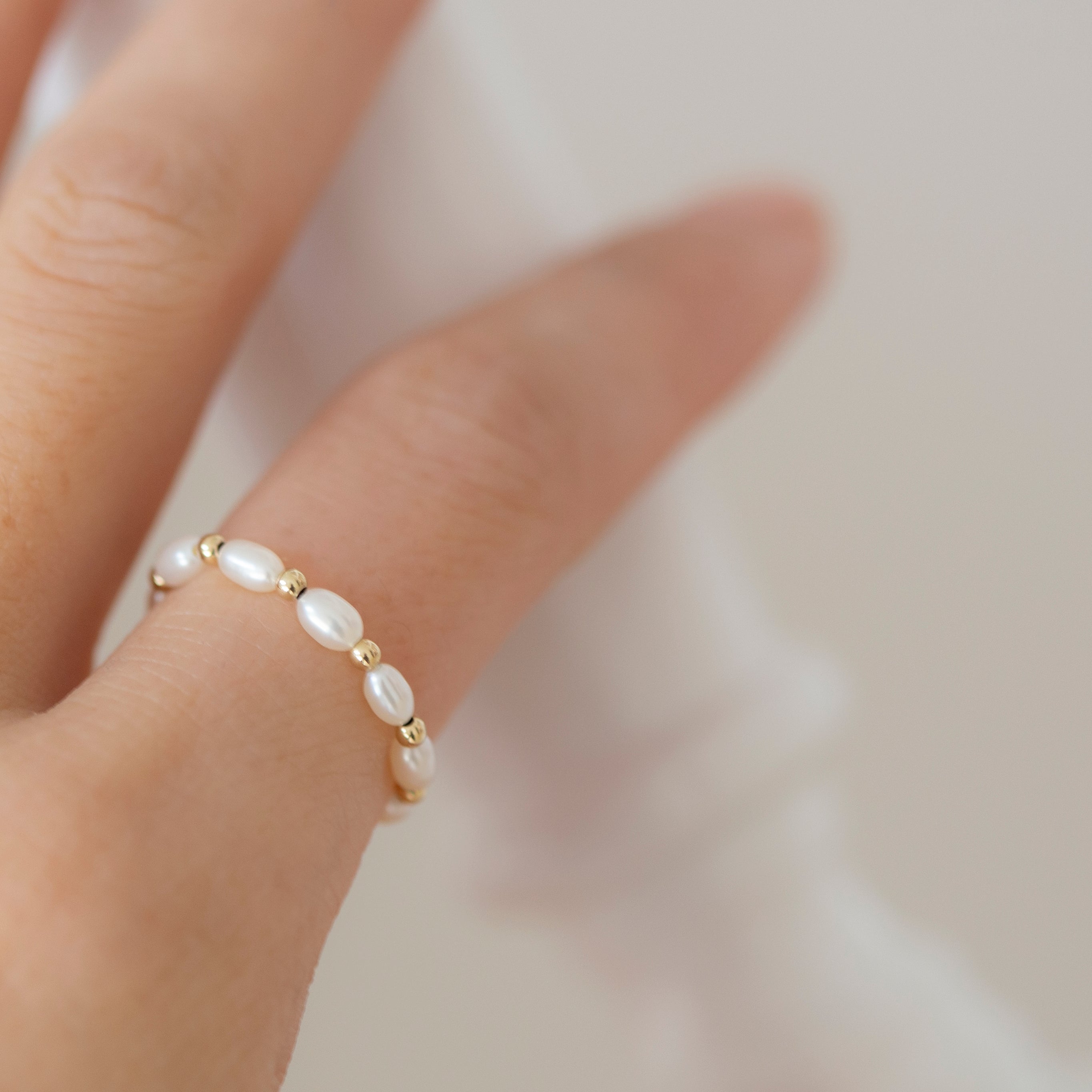 Baby Lotus Pearl Ring with Baby Beads
Made with mini rice shape fresh water pearls and mini gold filled bead on a
comfy stretchy elastic band. Baby lotus pearl ring will be the perfect addition to your ring stack!