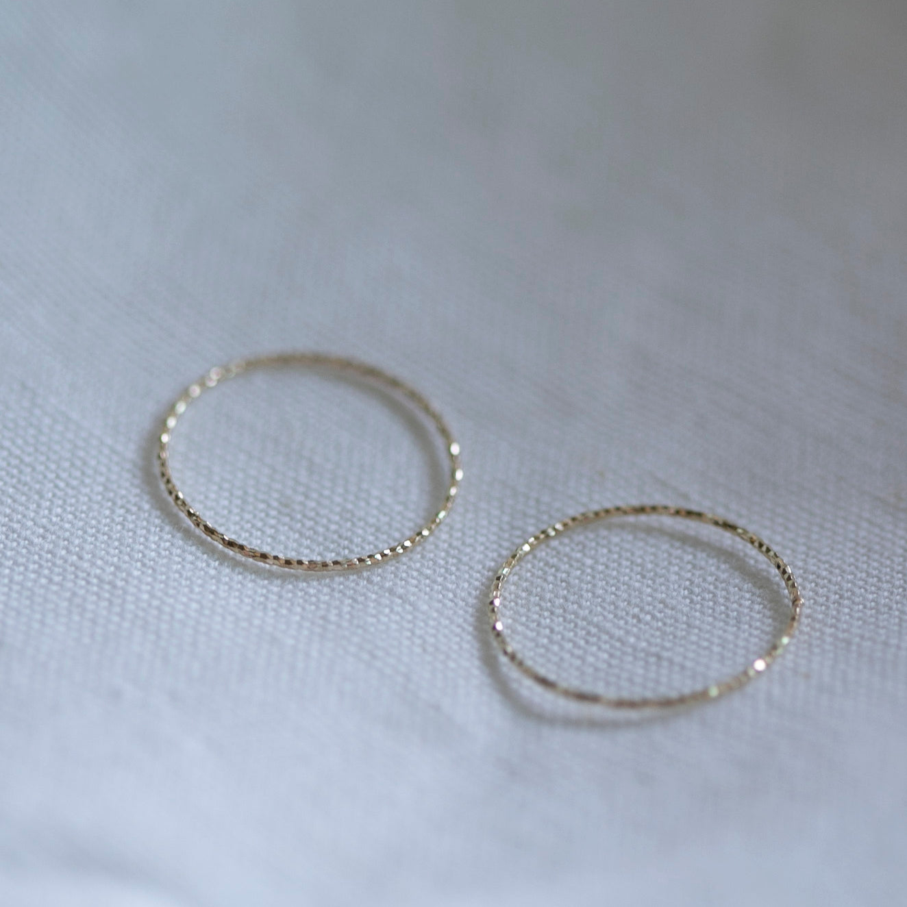 Crafted from 14k gold and featuring a diamond-cut design, these stacking rings offer a dainty and simplistic look that is perfect for everyday wear.