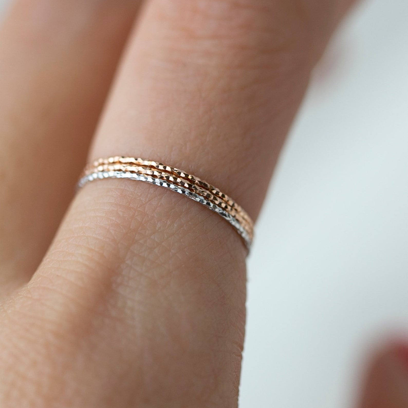 Crafted from 14k gold and featuring a diamond-cut design, these stacking rings offer a dainty and simplistic look that is perfect for everyday wear.