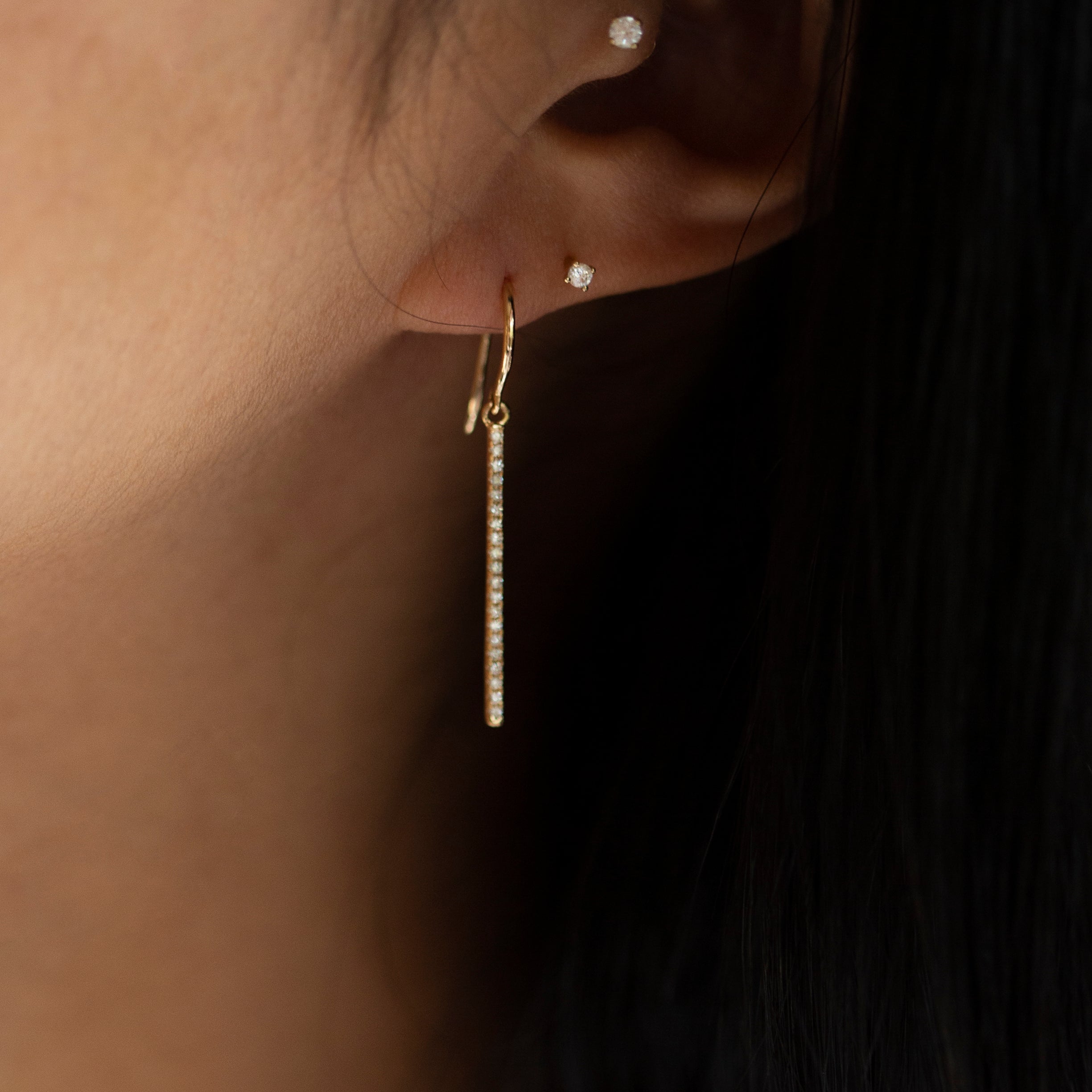 These exquisite 14k gold drop bar earrings feature genuine diamonds, adding a modern touch to their versatile design. A must-have for those seeking a timeless and sophisticated accessory.