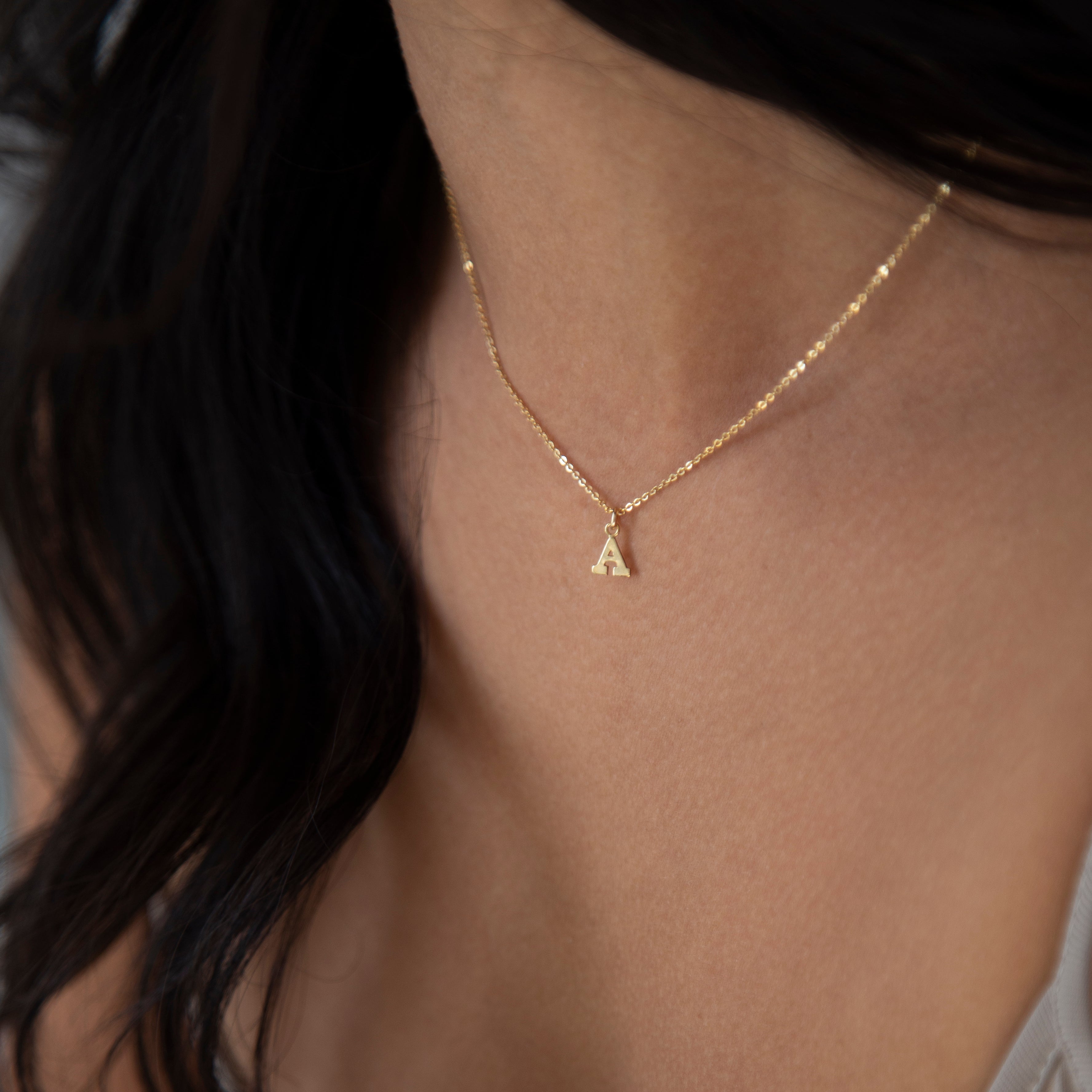Mini initial necklace, perfect for adding a personal touch to any outfit.
Dainty Initial Necklace - Perfect wearing alone or layering with your favorite necklaces.