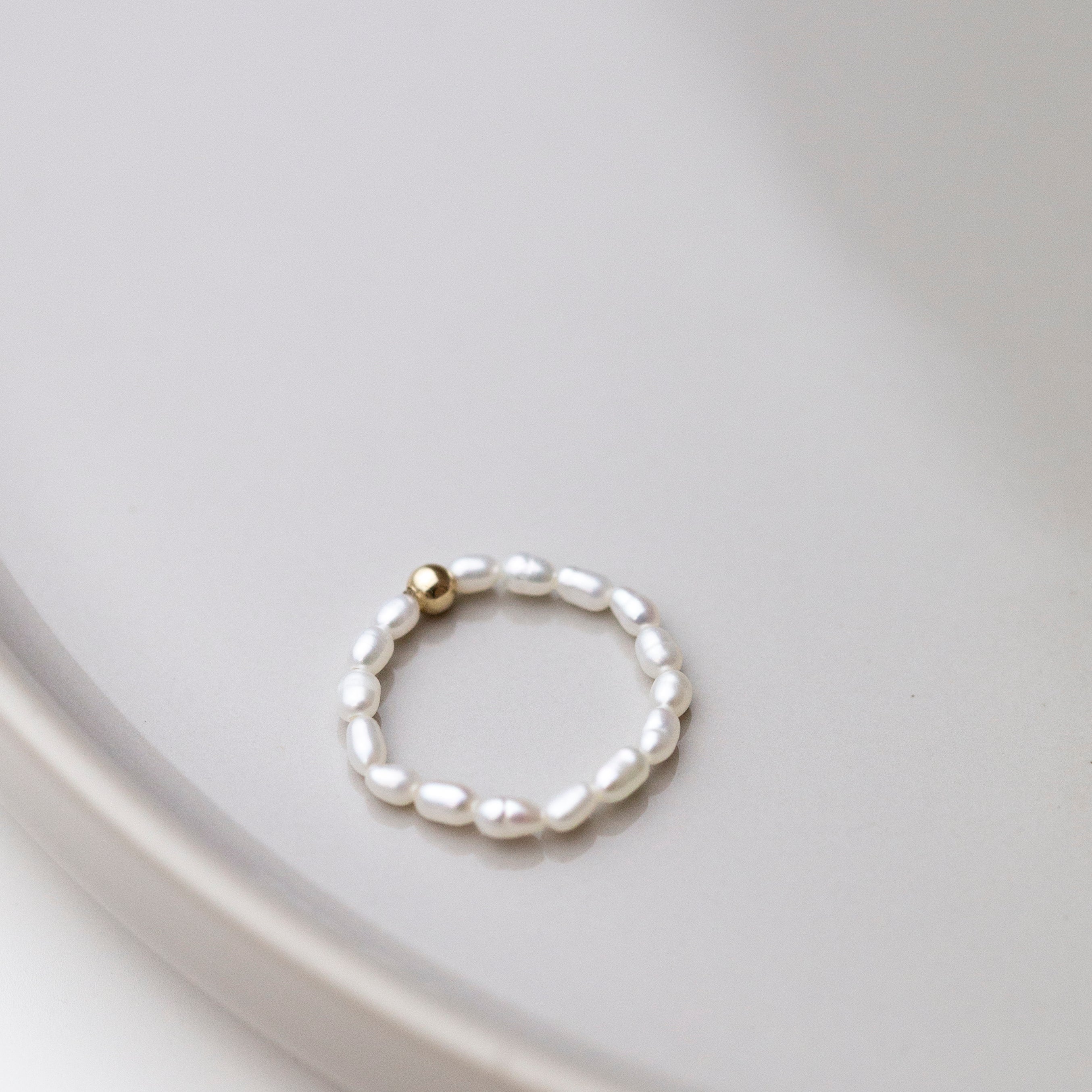 Baby Lotus Pearl Ring
Made with mini rice shape fresh water pearls and gold filled bead on a
comfy stretchy elastic band. Baby lotus pearl ring will be the perfect addition to your ring stack!