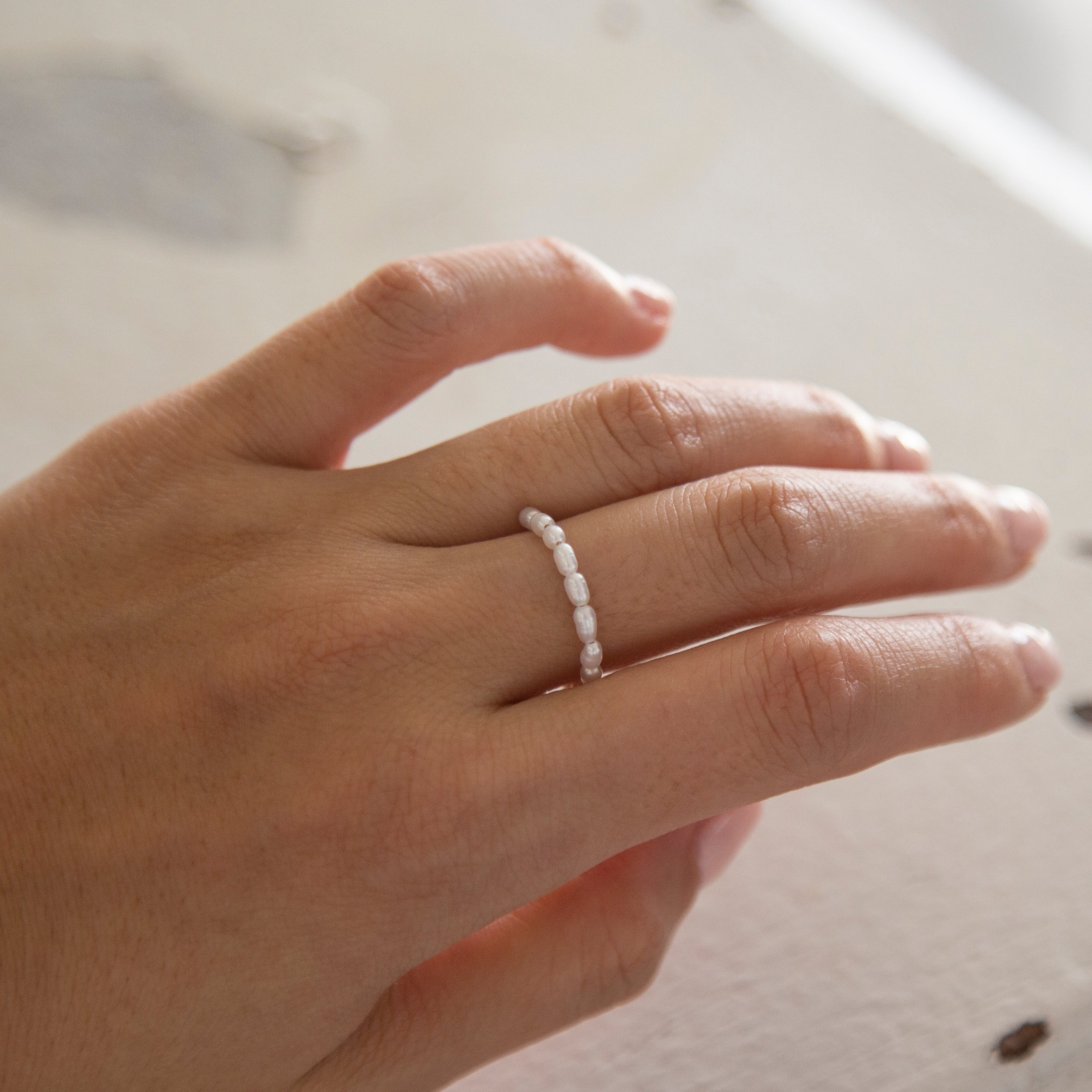 Baby Lotus Pearl Ring
Made with mini rice shape fresh water pearls and gold filled bead on a
comfy stretchy elastic band. Baby lotus pearl ring will be the perfect addition to your ring stack!