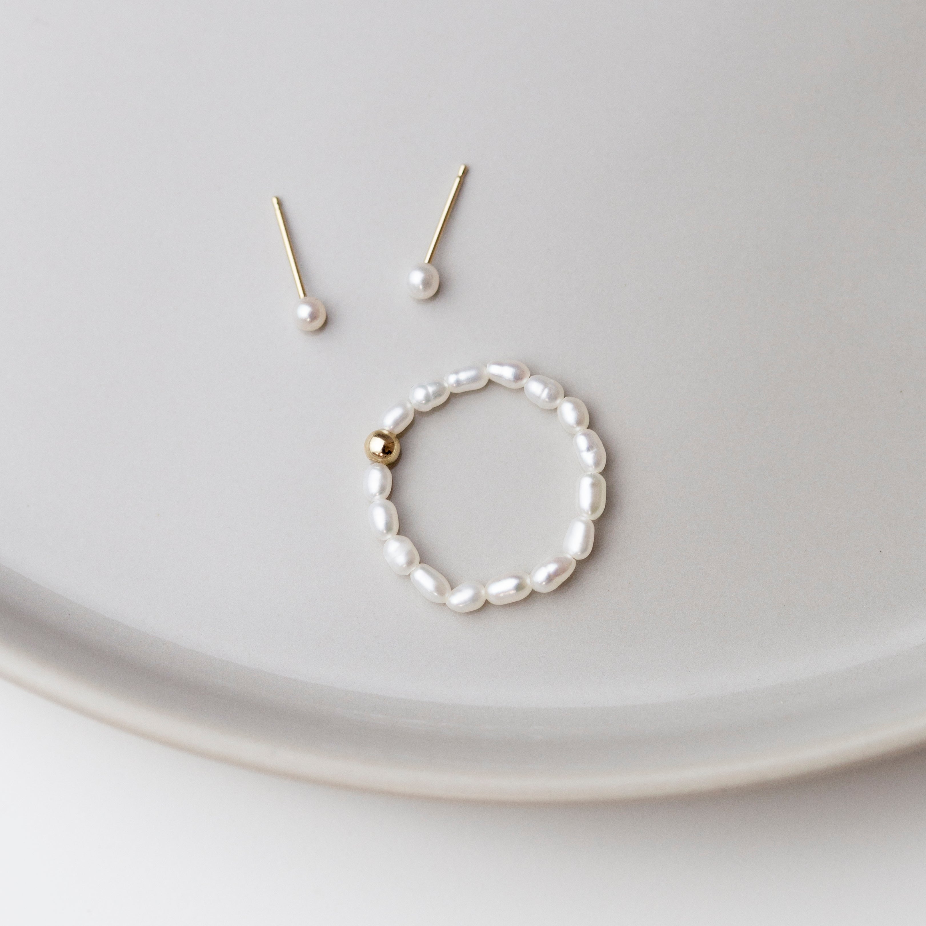 Baby Lotus Pearl Ring
Made with mini rice shape fresh water pearls and gold filled bead on a
comfy stretchy elastic band. Baby lotus pearl ring will be the perfect addition to your ring stack!