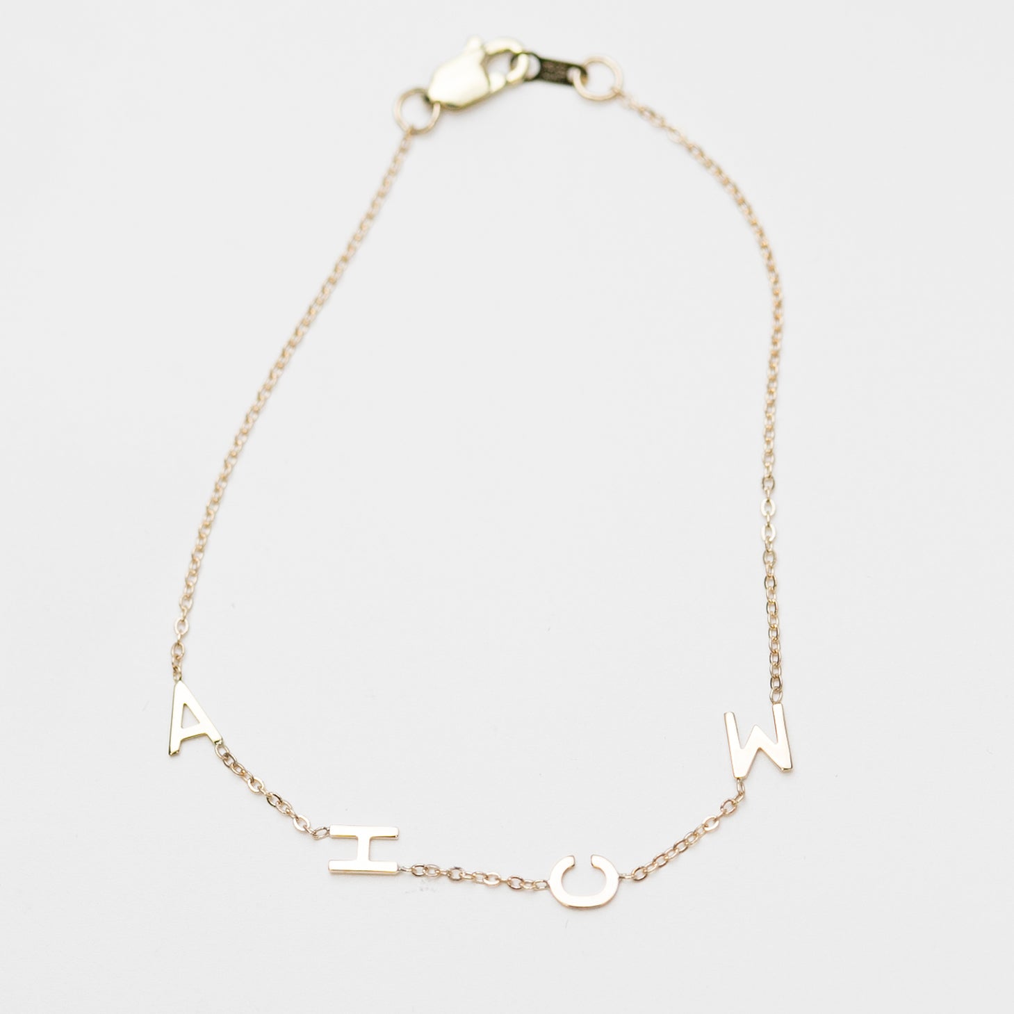 Customize your 14K solid gold initial bracelet. An understated, sleek everyday accessory. Ideal for gifting your loved one.