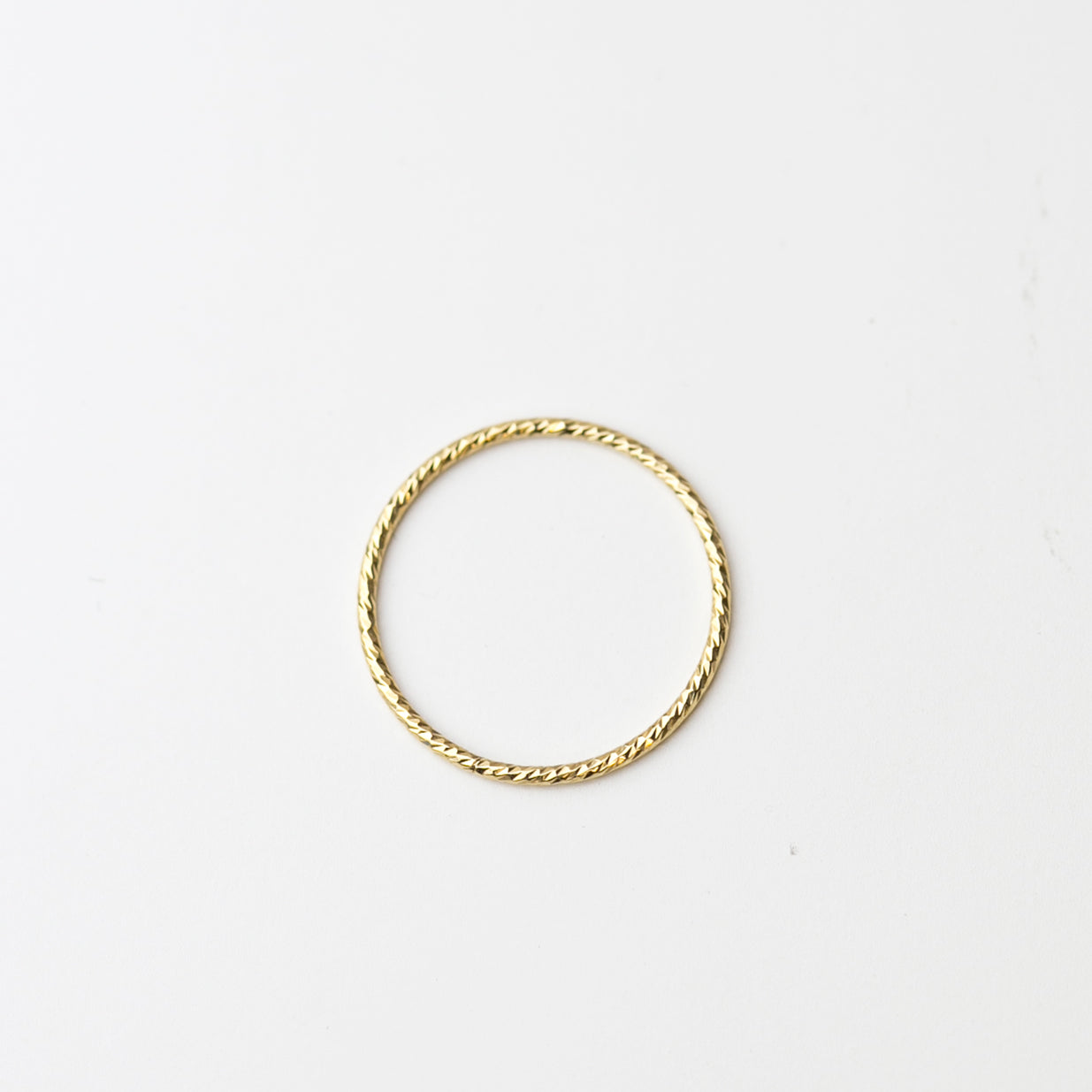 Crafted from 14k gold and featuring a diamond-cut design, these stacking rings offer a dainty and simplistic look that is perfect for everyday wear.