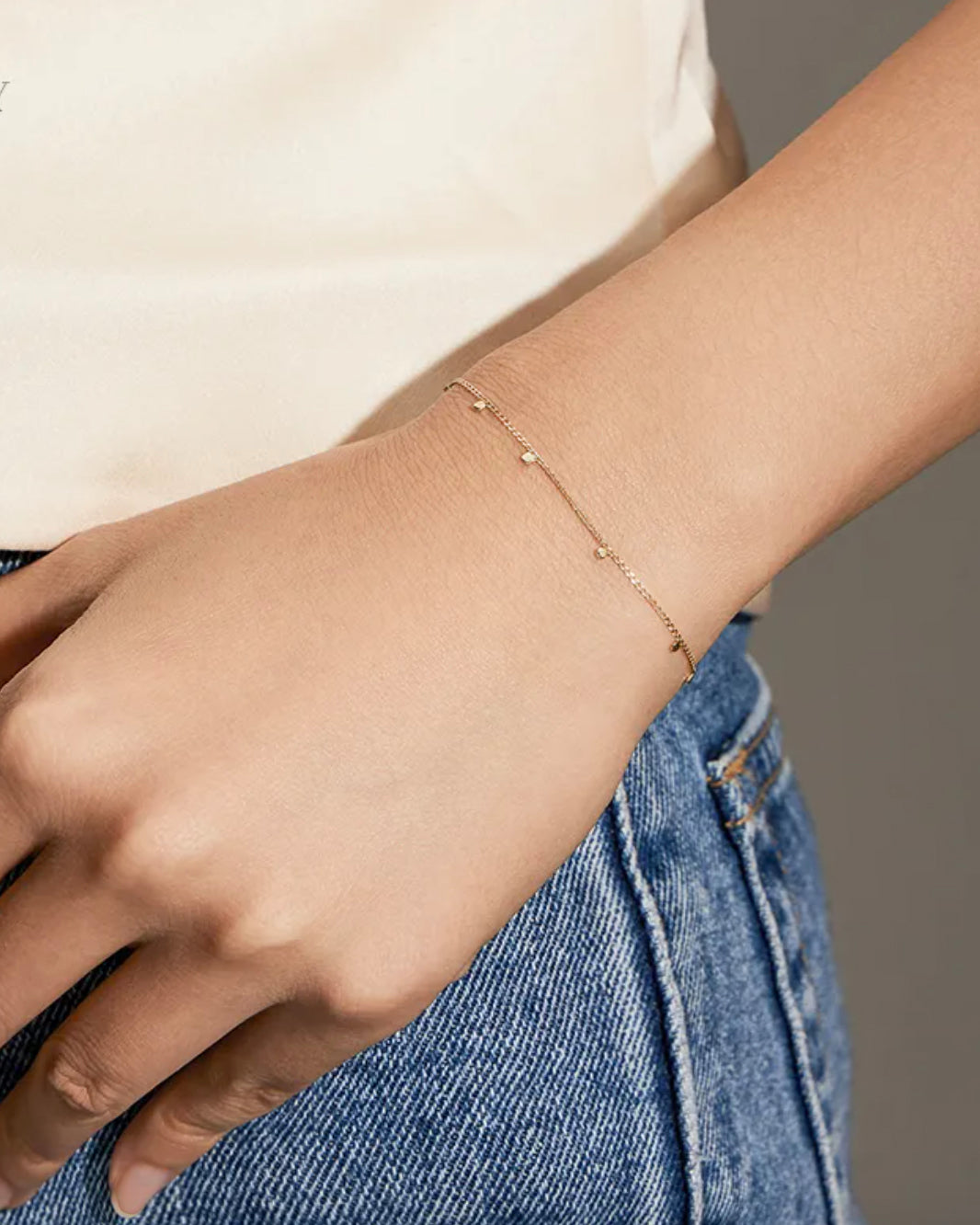 The chain is crafted with 14K yellow gold discs attached to a delicate 14K gold curb chain, creating a seamless row. Its bohemian and luxurious design allows for versatile styling, whether wearing alone or mixing with other favorites.