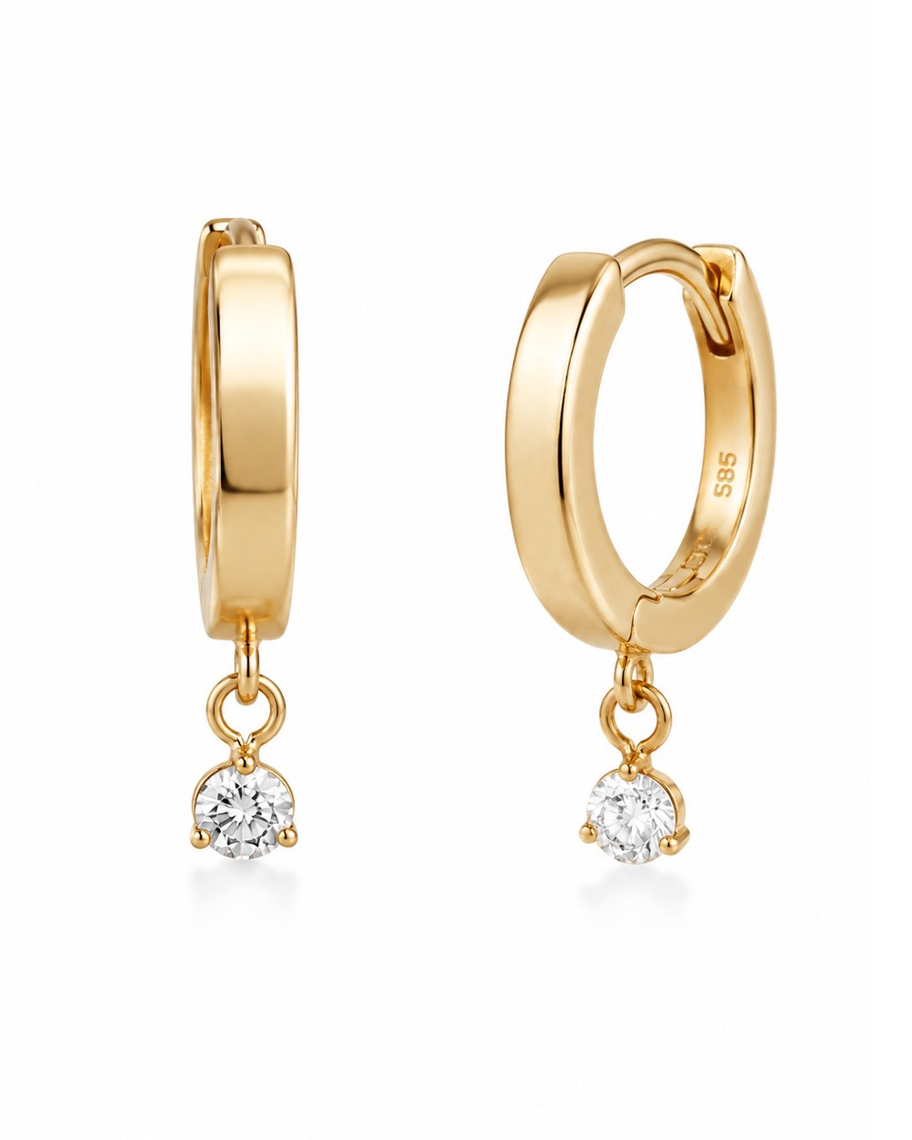 A pair of gold huggie hoop earrings with a small clear round-cut gemstone dangling from each hoop, shown on a clean white background.