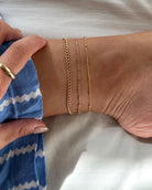 Our dainty chain anklet is the perfect accessory to elevate your summer style. Its subtle sparkle exudes elegance and sophistication, while also catching the eye with its glimmering light. Made from premium materials, this lightweight and durable anklet is designed to drape around the ankle beautifully, giving you a timeless look to wear day or night.