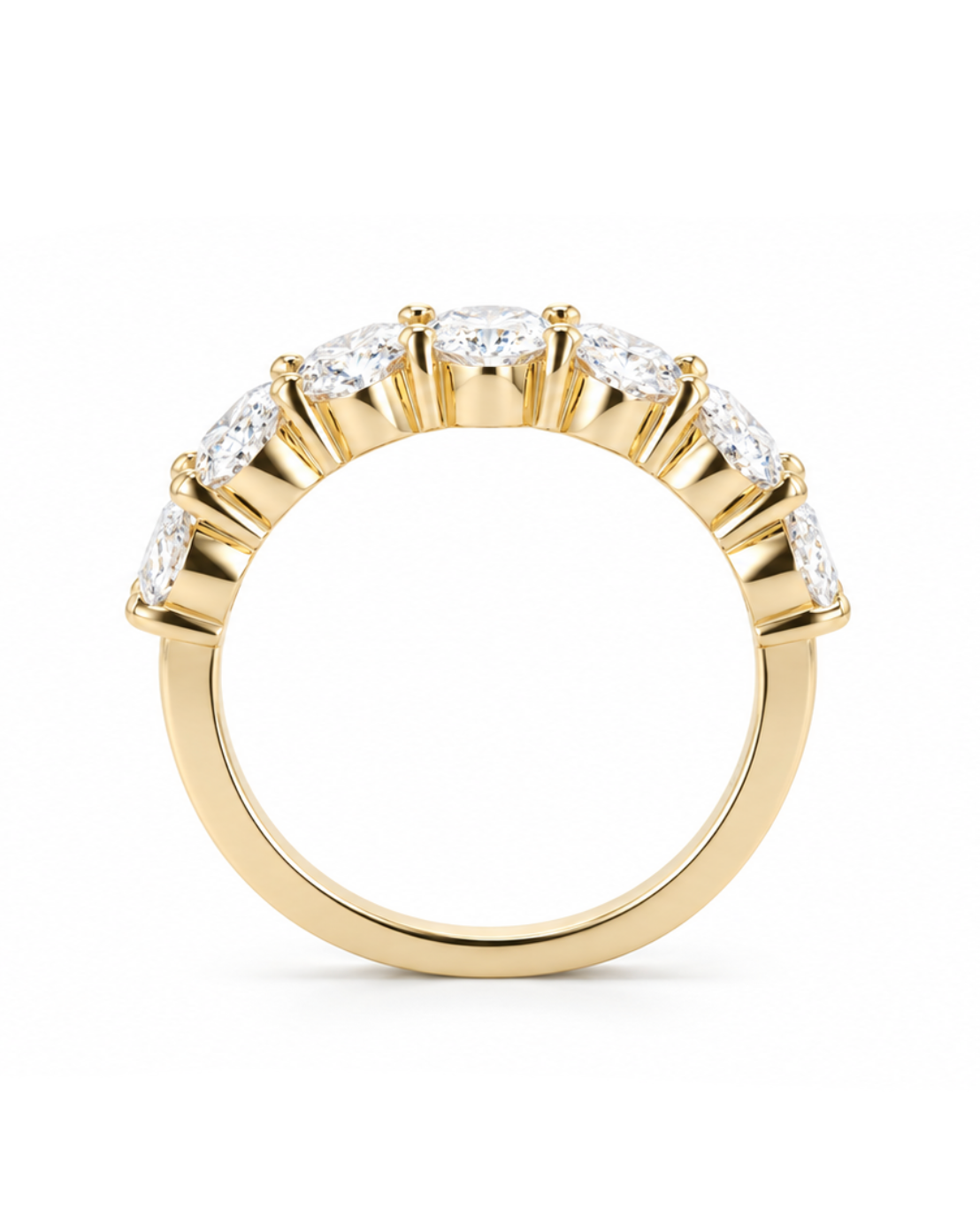 A yellow gold ring featuring a curved row of clear oval-cut gemstones in a prong setting, shown against a plain white background.