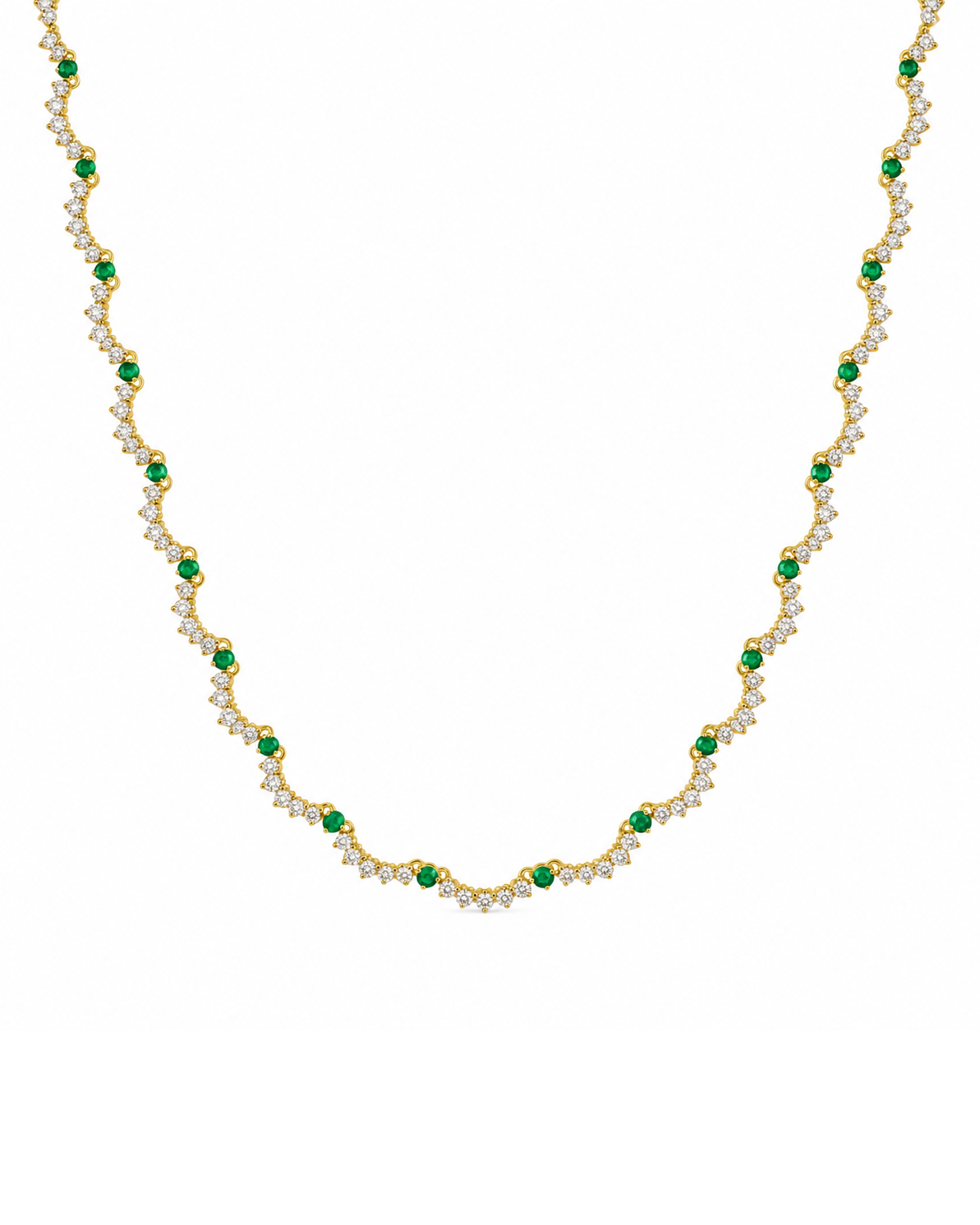 A gold necklace featuring a repeating wave pattern of small green emerald-cut stones and clear round-cut stones, displayed on a solid white background.