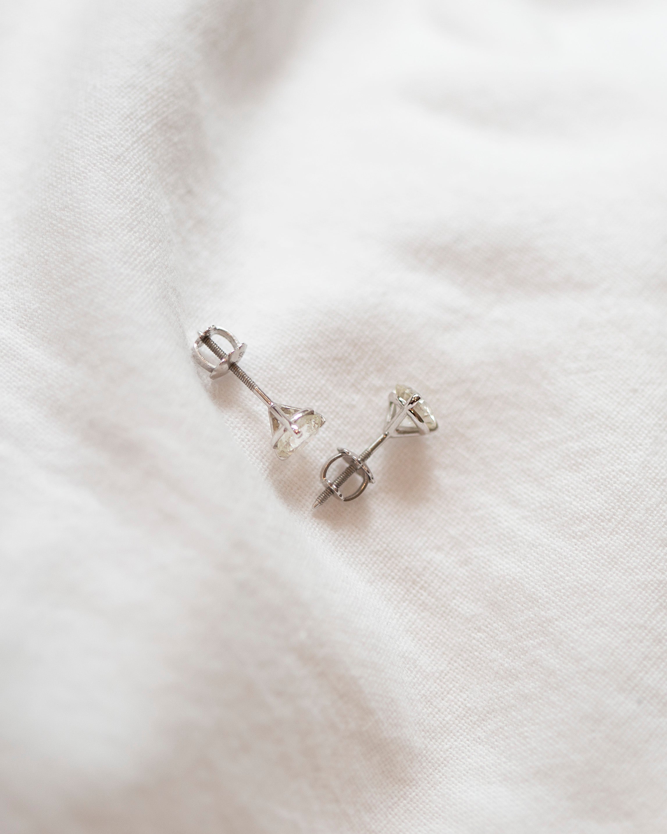 Enhance your elegance with these exquisite 14Kt gold lab diamond earrings, featuring a mesmerizing 1 Ct. TW. Martini set for a touch of sophistication. A must-have staple for every occasion.