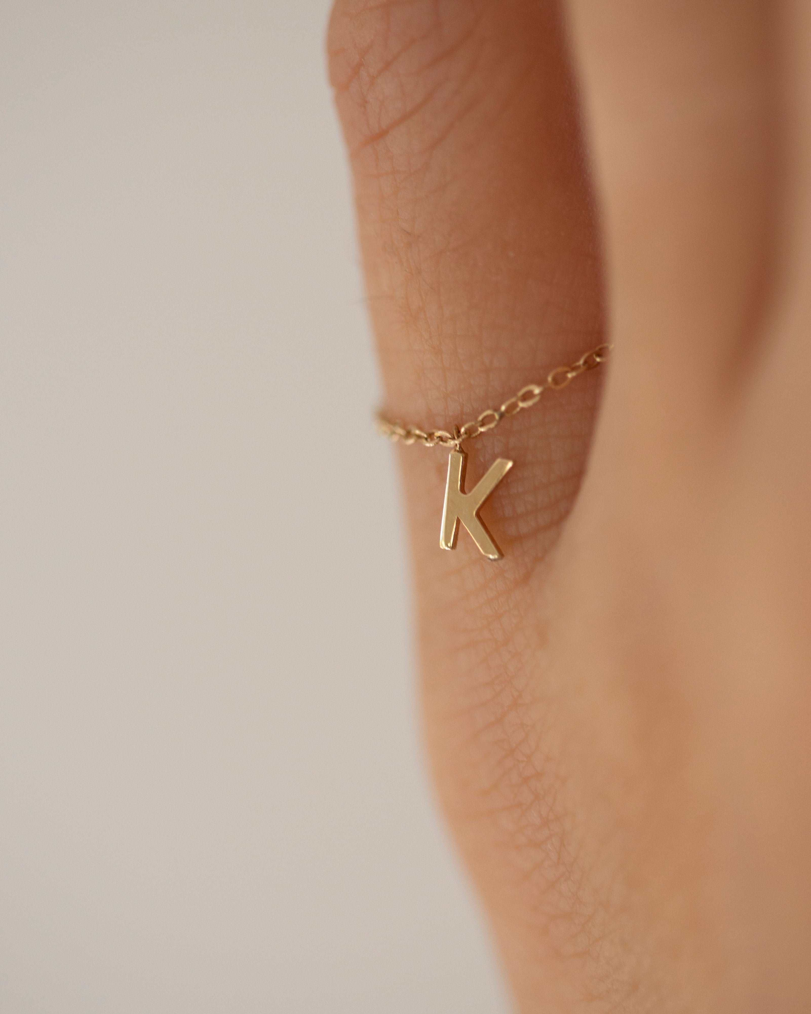 Barely there ring in 14k gold with small initial letter