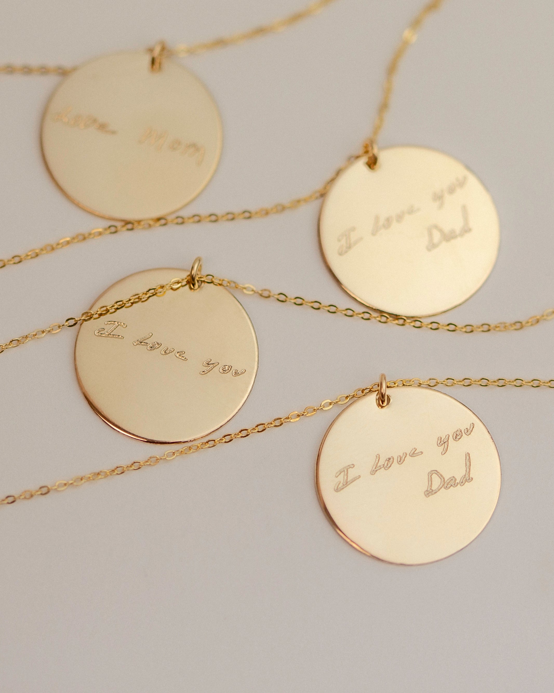  Each pendant has a handwritten message. The messages are 'I love you Dad', 'I love you Dad', 'I love you', and 'Love Mom'.