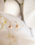 These 14k gold earrings feature a 7mm white cultured pearl and secure lever back closure.