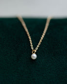 This Mini Pearl Pendant Necklace is the perfect complement for your evening wear or casual wardrobe. Crafted from 14k gold, this delicate necklace features a small cultured pearl, lending it a minimalist and elegant look. With this classic and versatile accessory, you're sure to make a statement.