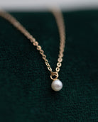 This Mini Pearl Pendant Necklace is the perfect complement for your evening wear or casual wardrobe. Crafted from 14k gold, this delicate necklace features a small cultured pearl, lending it a minimalist and elegant look. With this classic and versatile accessory, you're sure to make a statement.