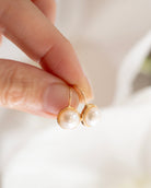 These 14k gold earrings feature a 7mm white cultured pearl and secure lever back closure.