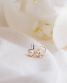 These 14k gold earrings feature a 7mm white cultured pearl and secure lever back closure.