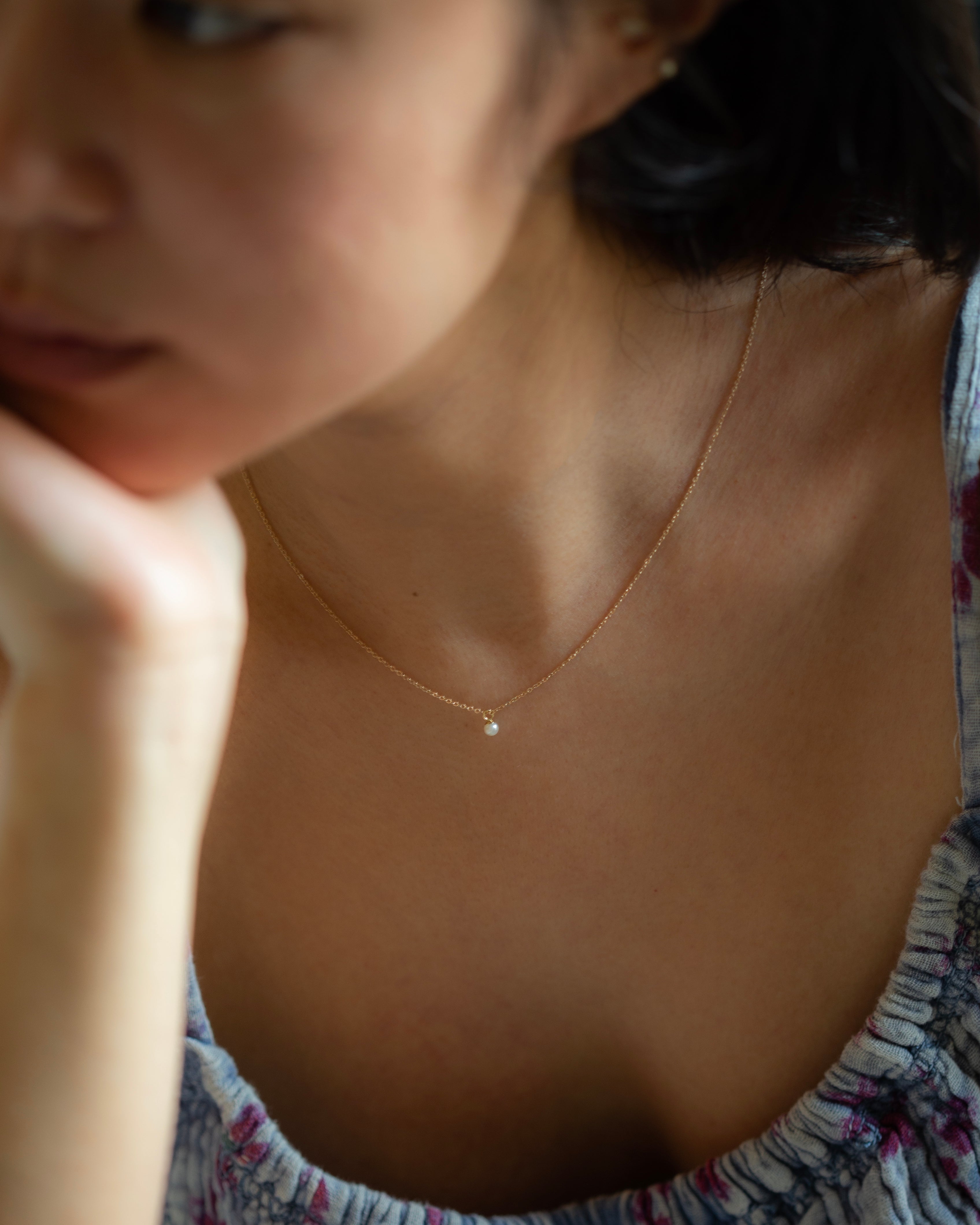 This Mini Pearl Pendant Necklace is the perfect complement for your evening wear or casual wardrobe. Crafted from 14k gold, this delicate necklace features a small cultured pearl, lending it a minimalist and elegant look. With this classic and versatile accessory, you're sure to make a statement.