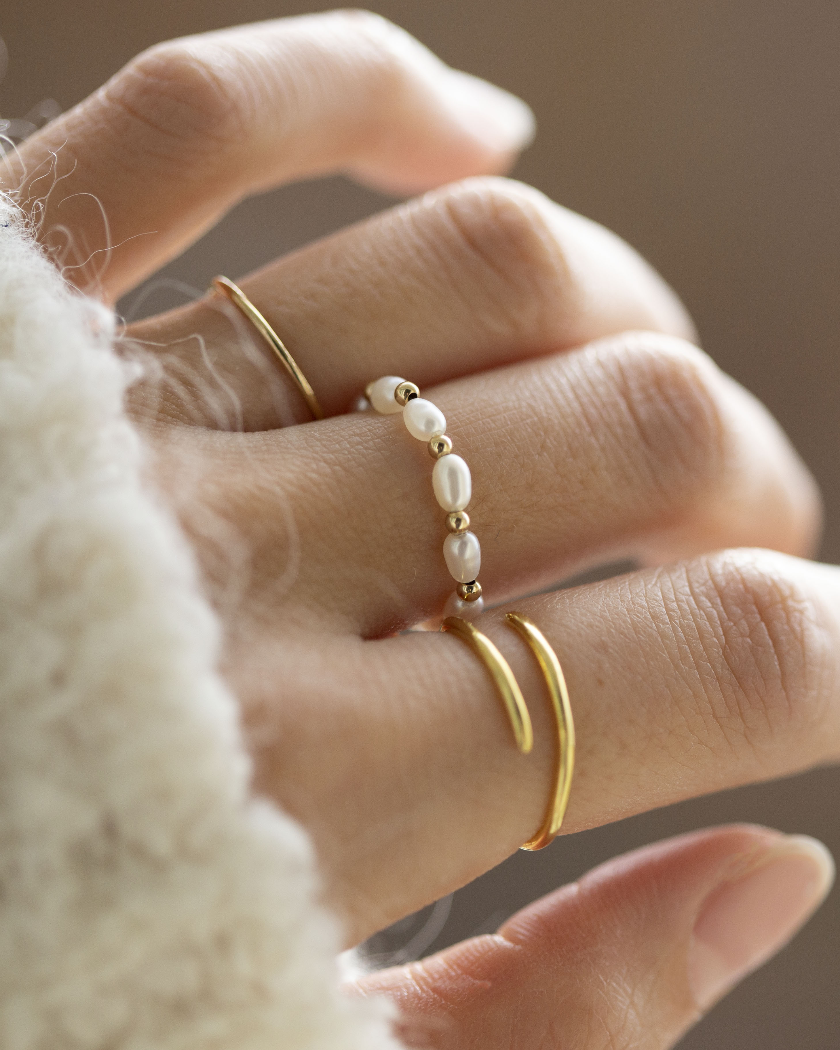 Baby Lotus Pearl Ring with Baby Beads

Made with mini rice shape fresh water pearls and mini gold filled bead on a
comfy stretchy elastic band. Baby lotus pearl ring will be the perfect addition to your ring stack!