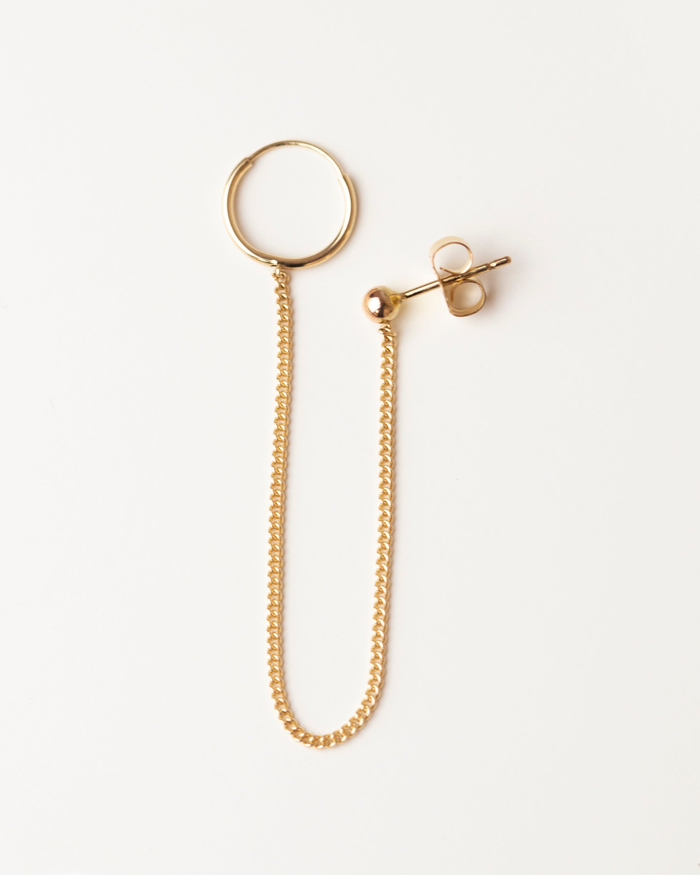 14k Gold Hoop Chained Earring

Small Hoop chained onto 3mm ball stud earring.
The 14k gold hanging chain makes this earring unique and chic.