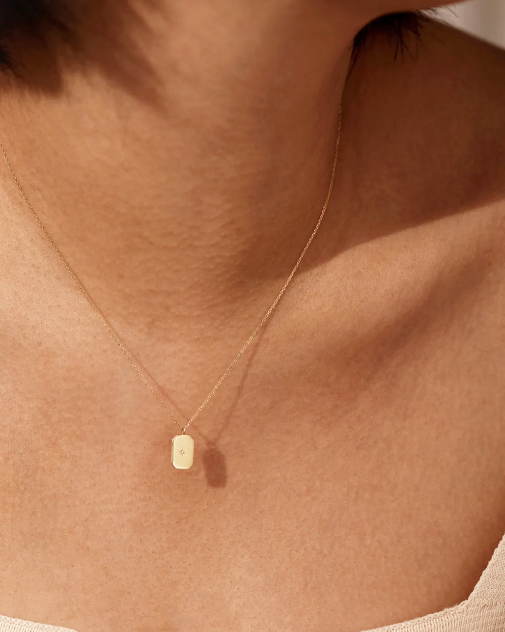 This 14k Gold Mini Diamond Tag Necklace is minimalistic and simple, yet adds a special touch with its small diamond star tag. It provides the perfect everyday accessory when worn alone or layered with other necklaces.